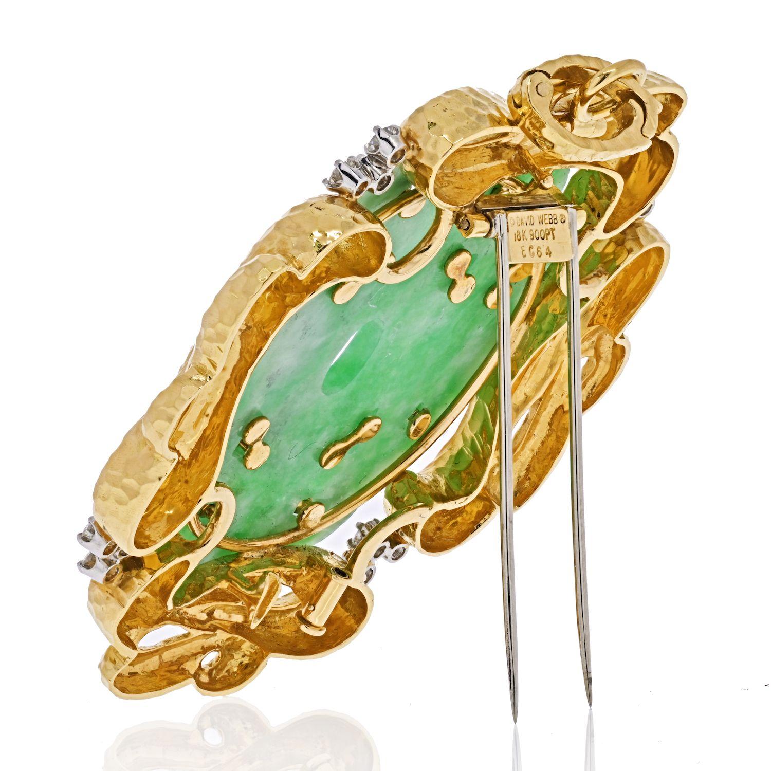 Aesthetically pleasing and executed in rich 18K yellow gold, this 1960s vintage brooch highlights a beautiful bright translucent apple green jade, fancifully hand-carved with ancient looking design. Framed with gold scrolls that are adorned with 34