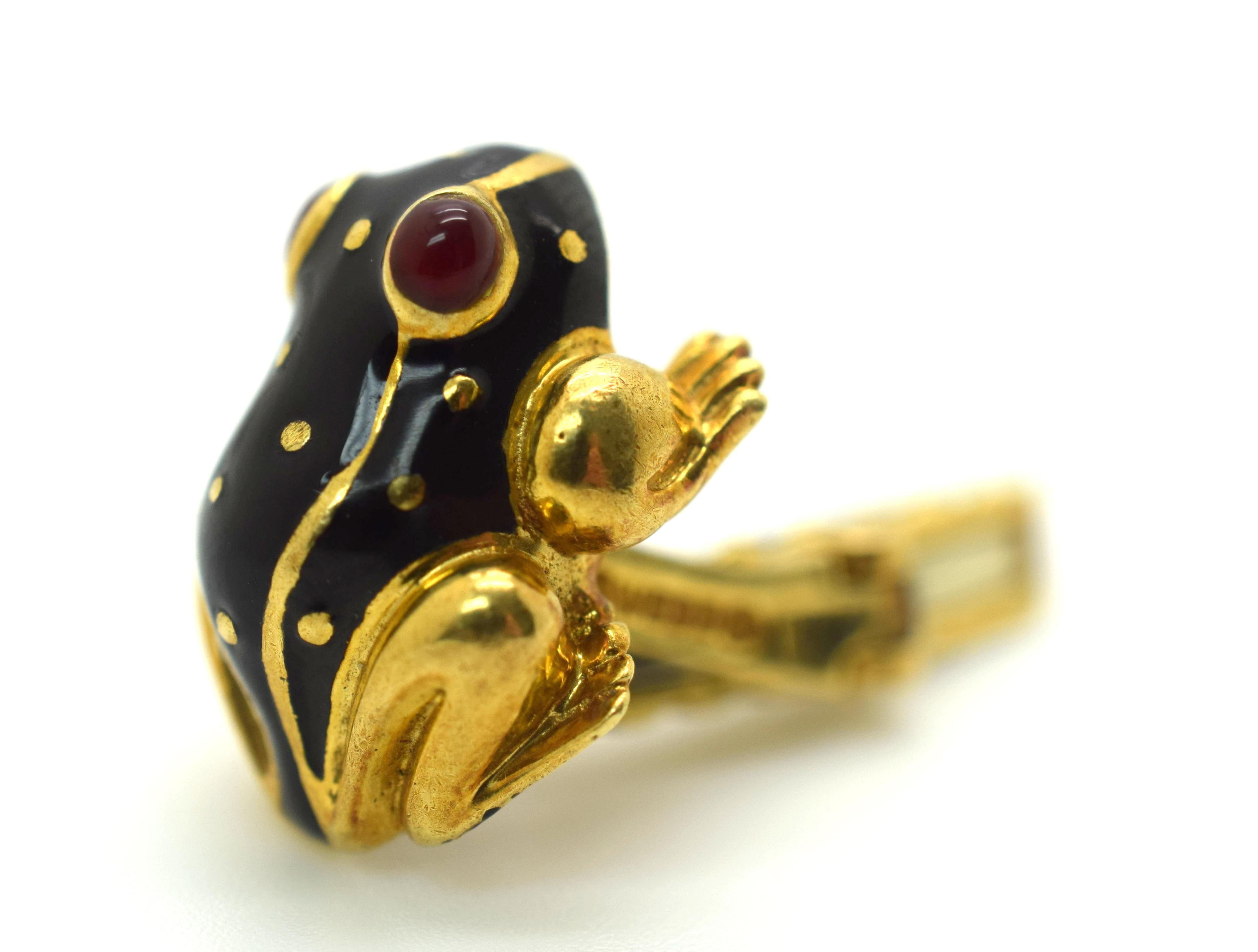 Fantastic design by famed designer David Webb. These cuff links are in amazing vintage condition. Crisp black enamel is showcased on the frogs backside with golden dots throughout. Eyes are red enamel with a decorative black enamel design of the
