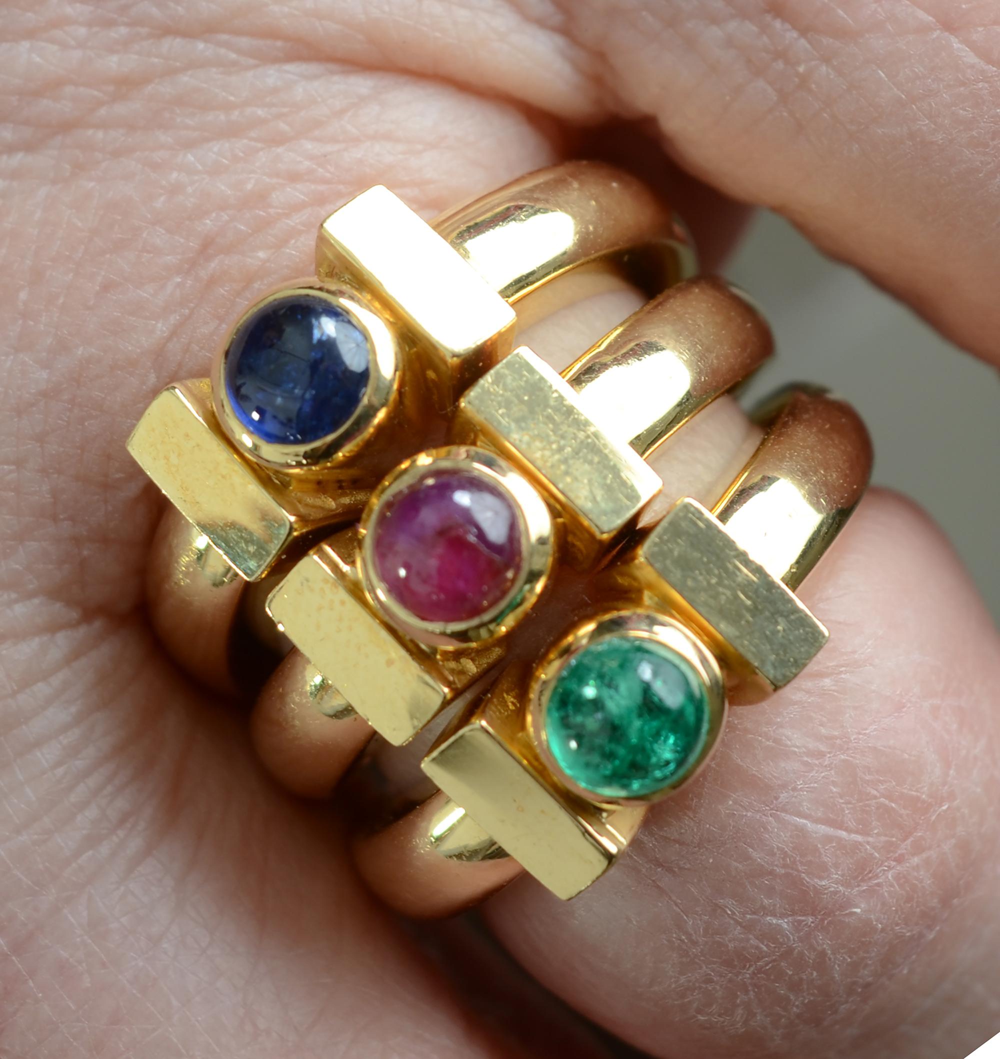 Versatile group of three solitaire rings by David Webb that can be worn singly or combined. One has a ruby; one an emerald and one a sapphire. All of the stones are cabochon cut. The rings are size six; they can be made larger or smaller.