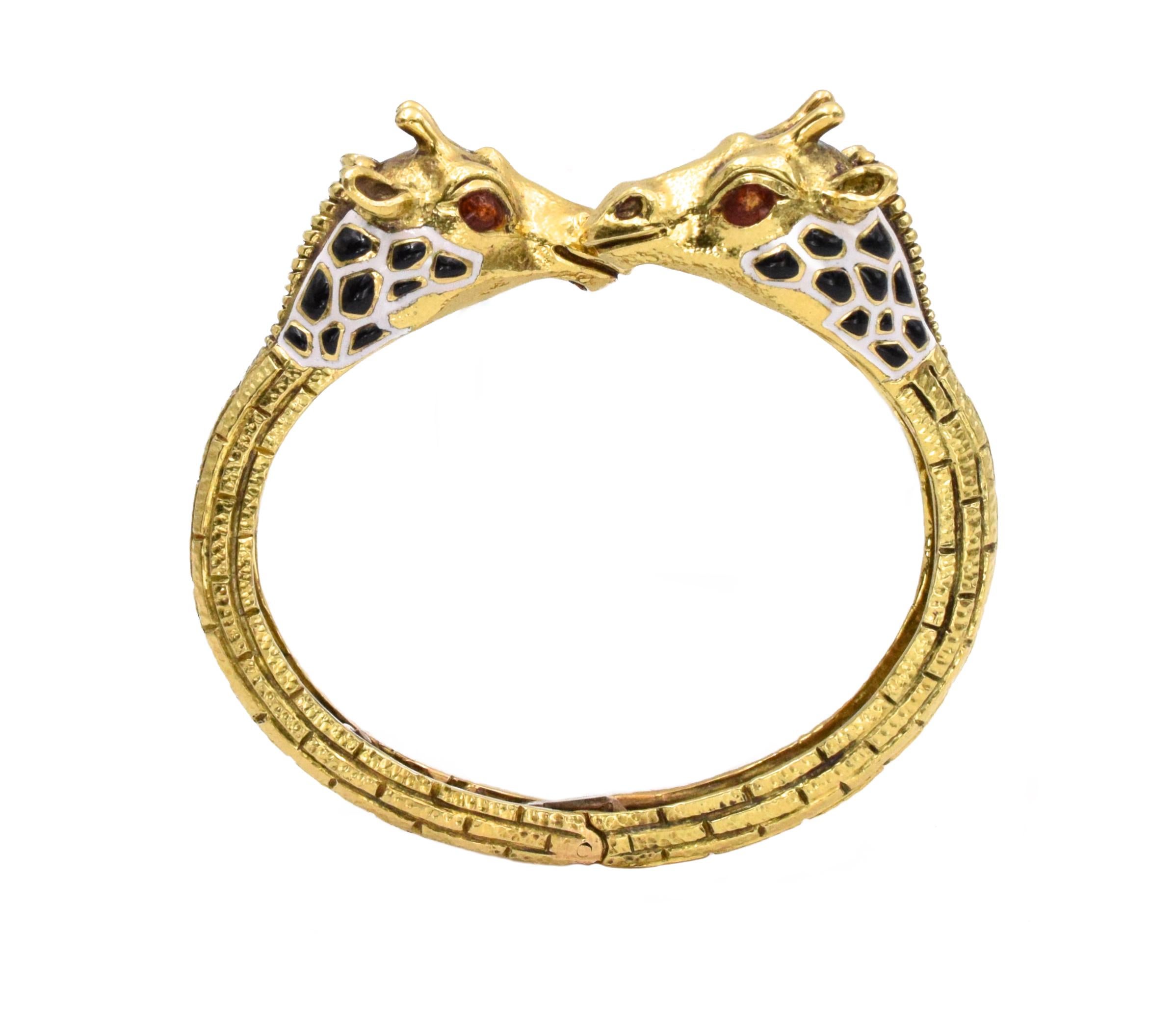 David Webb Giraffe Gold and Enamel Bangle The bangle bracelet has 2 giraffe heads made out of black, white, and red enamel and 18 k yellow gold.
Signed: David Webb
Wrist size is 6. Weighs 61.3 grams
