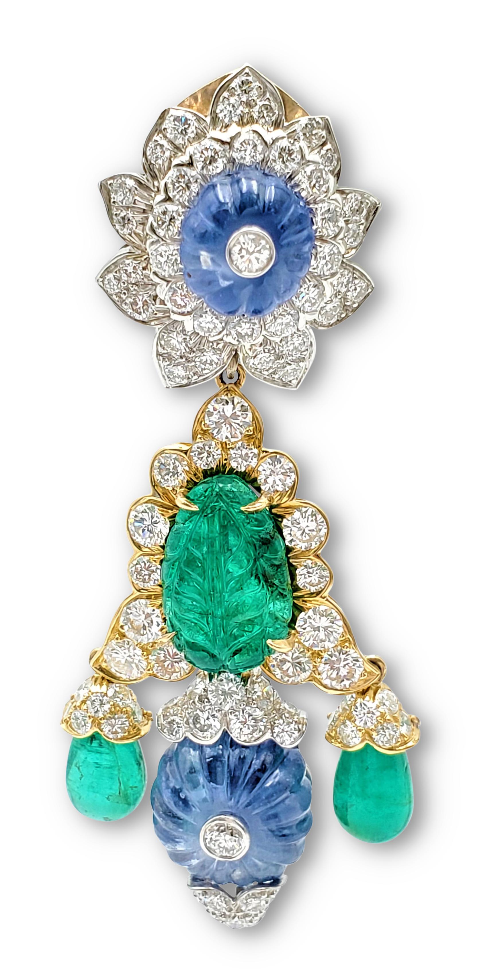 An impressive pair of earrings designed by David Webb. Easily converted from day-to-night, the earrings feature two detachable drops. Crafted in 18 karat yellow gold and platinum, the earrings center on carved emeralds, carved sapphire fluted beads,