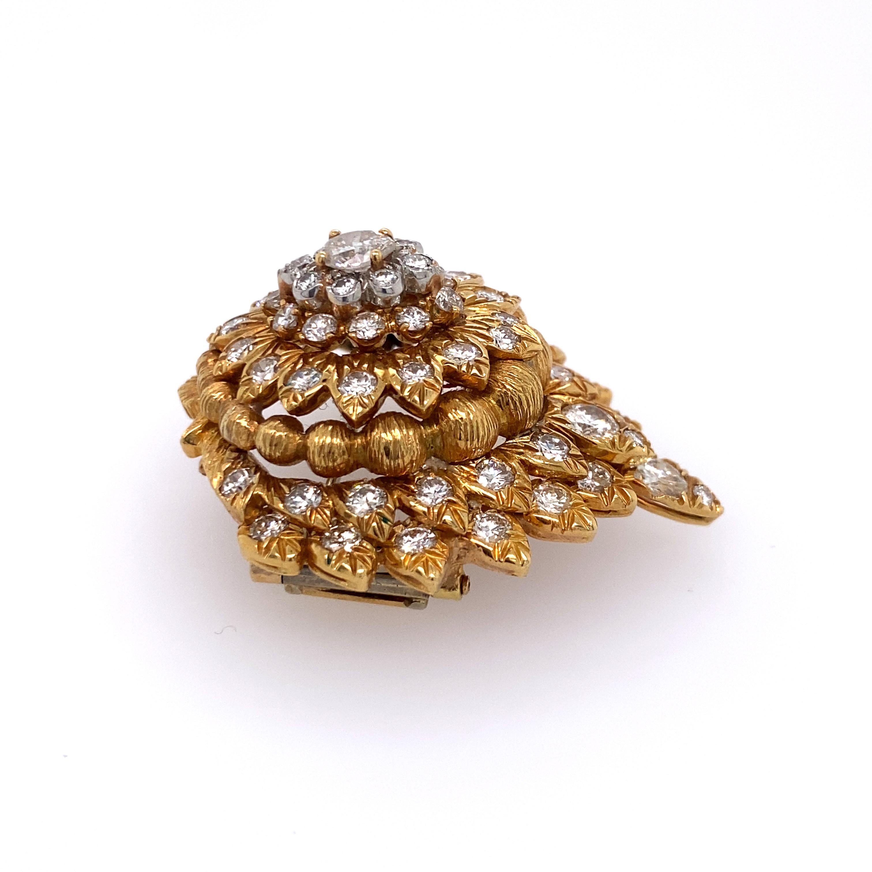 Signed David Webb 18kt yellow gold and diamond brooch. Central pear-shaped diamond measures approx. 4.0mm x 5.0mm or approx. 0.35cttw. Total approx. weight is 15.0 dwt. Dimensions: brooch measures approx. 1.38