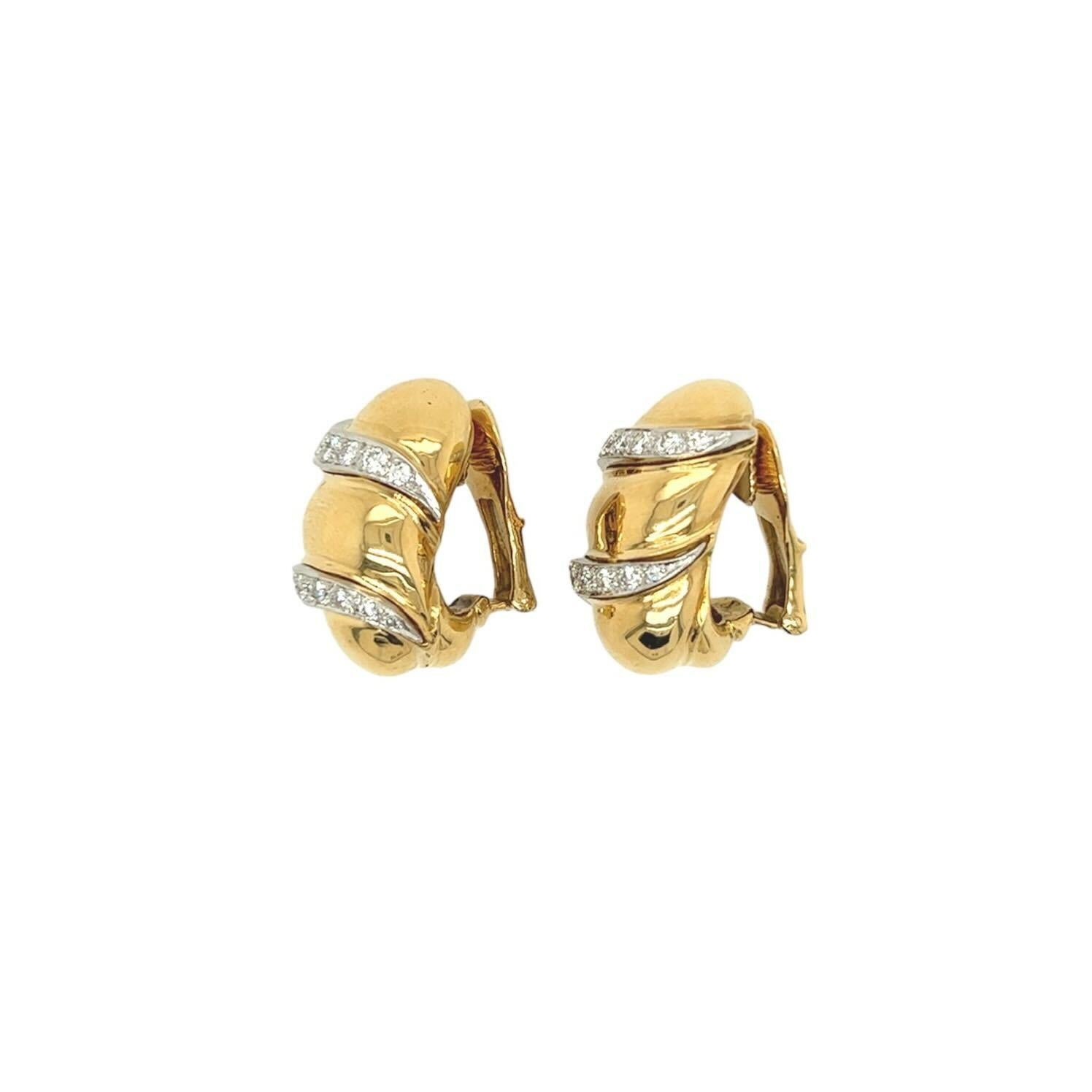 A pair of 18 karat yellow gold and diamond earclips, David Webb.  Each earclip designed as bombe oval applied with two undulating diagonal rows set with eighteen (18) round brilliant cut diamonds.  Total diamond weight approximately 1.42 carats. 