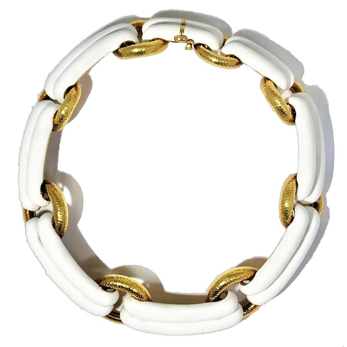 This magnificent David Webb 18k hammered finish gold and white enamel necklace is absolutely striking, not only because of it's simple and imaginative design, but because of it's grand scale as well. At it's widest point in the front, it measures a