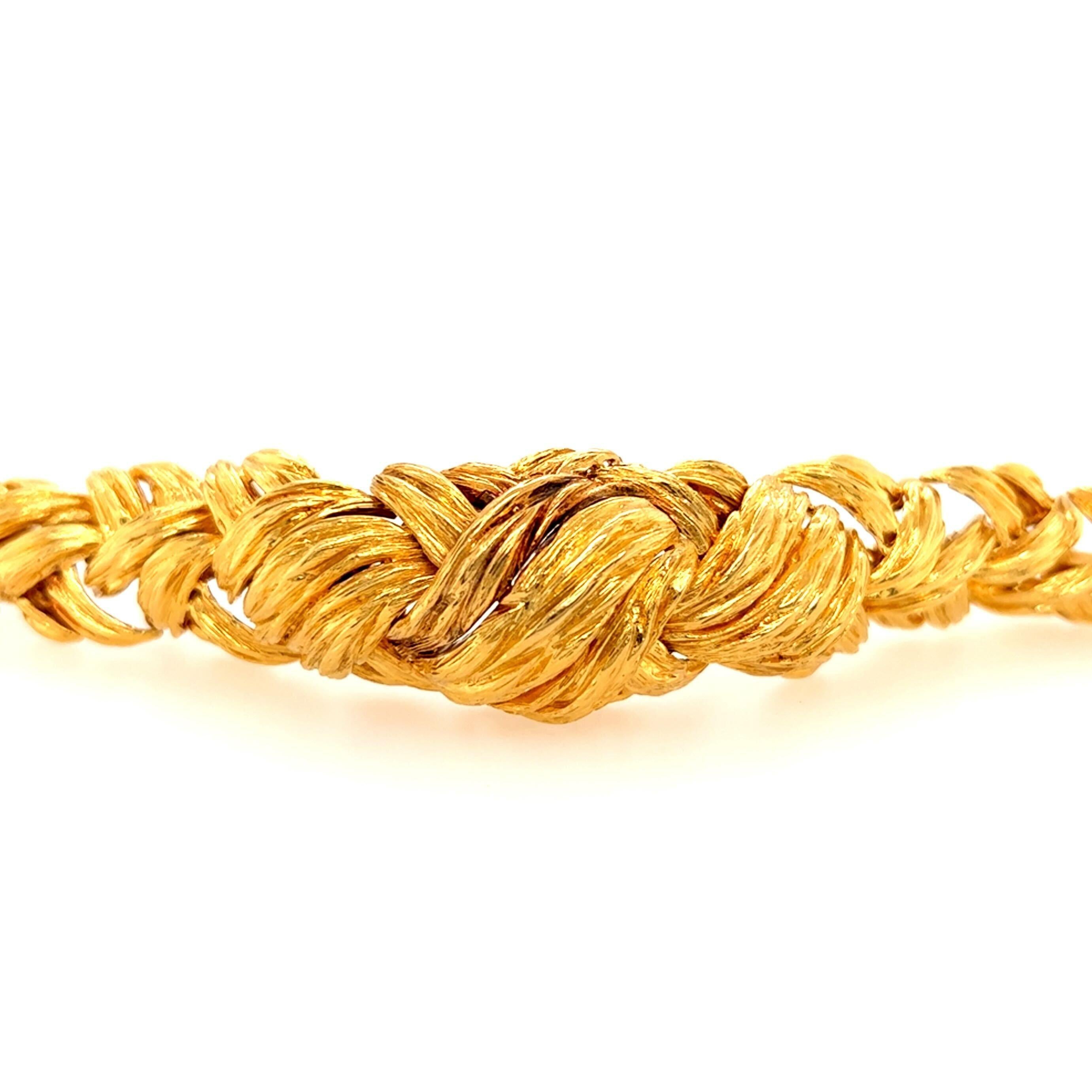 An 18 karat yellow gold bracelet, David Webb.  Designed as a graduated stylized braid of textured gold.  Length approximately 6 inches.  Gross weight approximately 9.40 grams.  Signed Webb.
