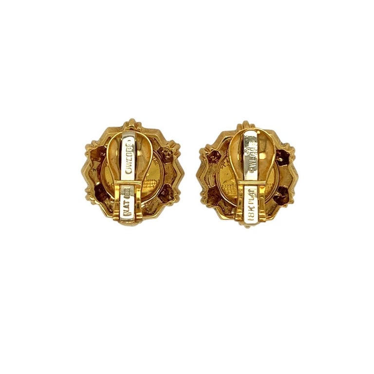 A pair of high karat and 18 karat yellow gold earclips, David Webb.  Each earclip centering a five yuan gold coin depicting a panda, in a hexagonal frame with a bracket on each side holding the coin in place.  Length approximately 3/4 inch.  Gross