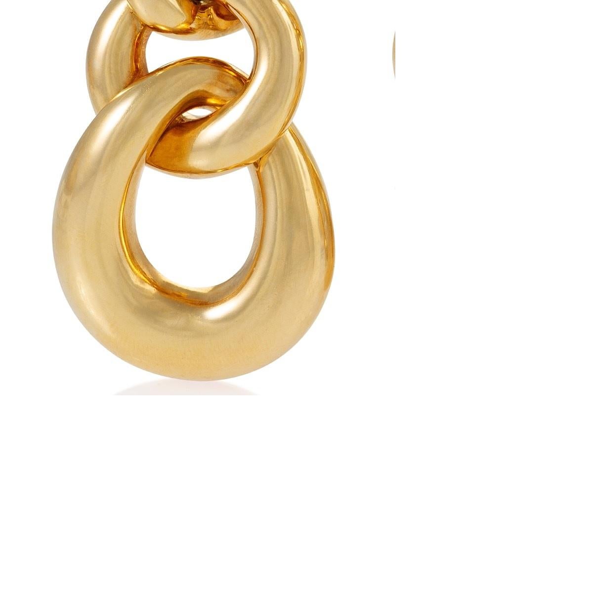 A pair of American mid-20th century 18 karat triple hoop gold earrings by David Webb. These earrings demonstrate the strength and elegance of design for which the firm is famous. The chunky gold piece is comprised of three stylized, over-sized