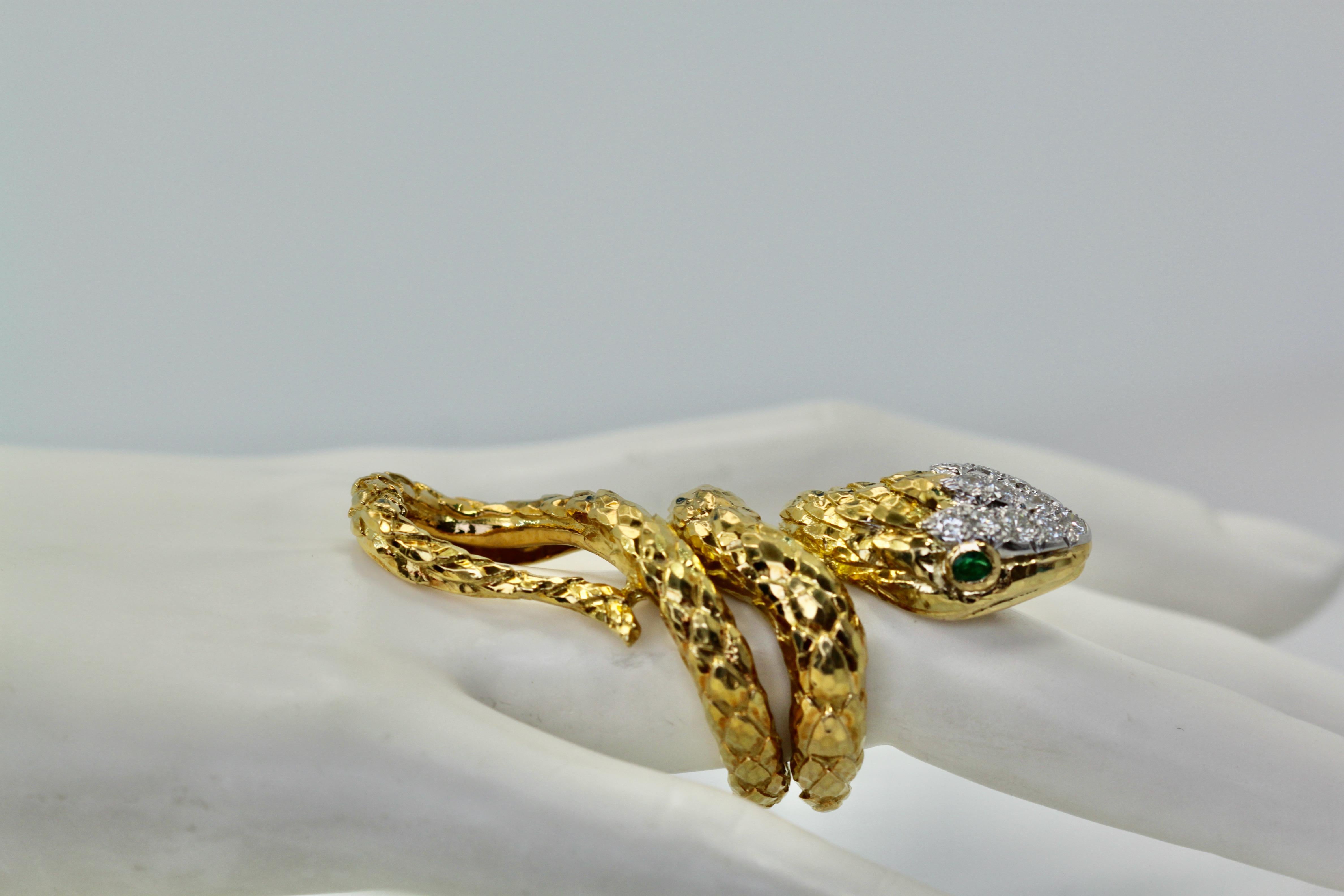 This David Webb ring is a bit unusual as it has a nice hand carved textured snake body with a curl to his long tail.  The two eyes are Emerald and it has a full Diamond head set in platinum, the body of the ring is 18K yellow gold.  This piece is