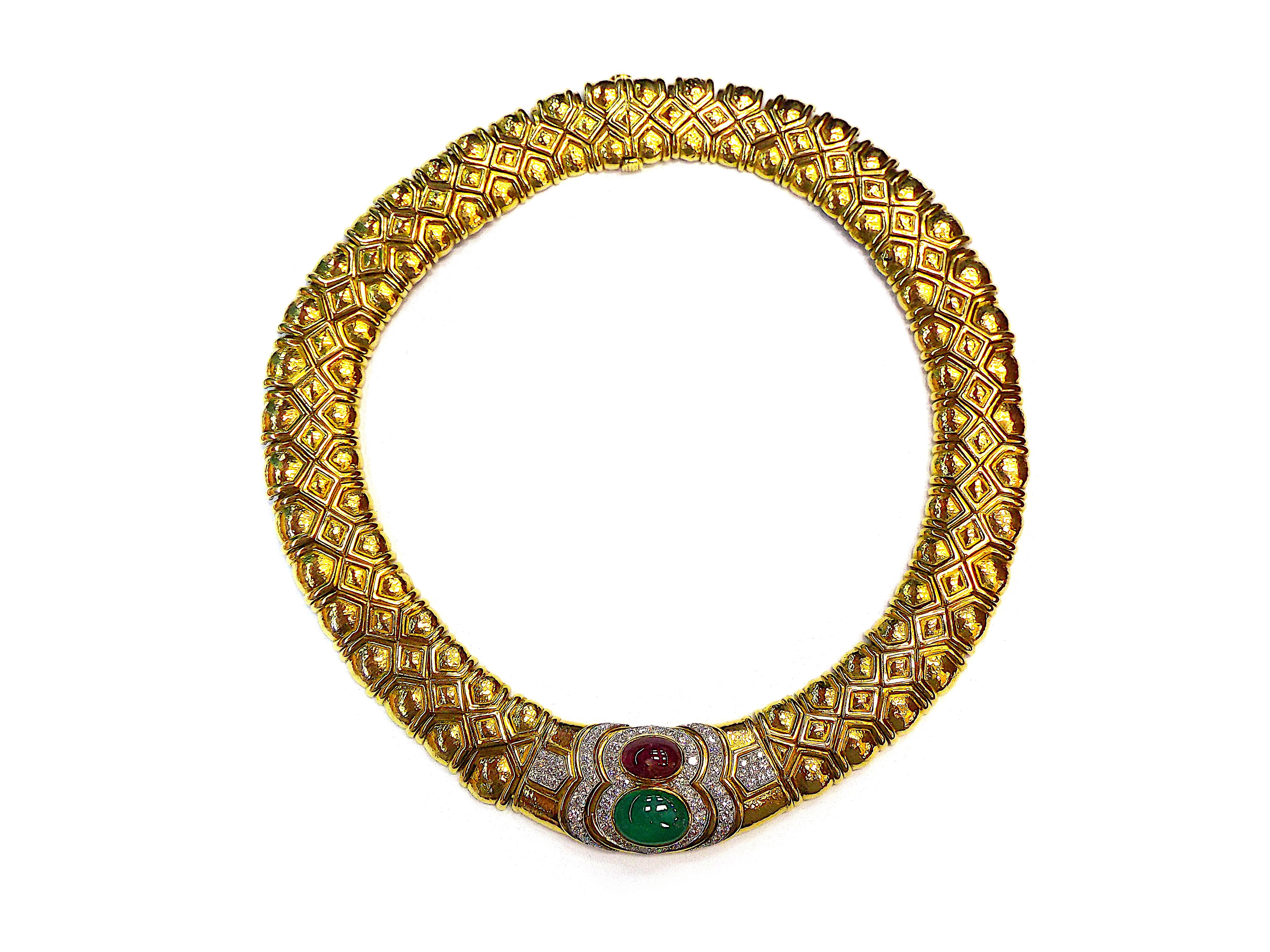 The wide gold necklace composed of geometric hammered gold links, featuring a cabochon emerald and ruby, framed and accented by round diamonds, together with a pair of earclips of similar design.
Diamonds weigh a total of approximately 8.00 carats.