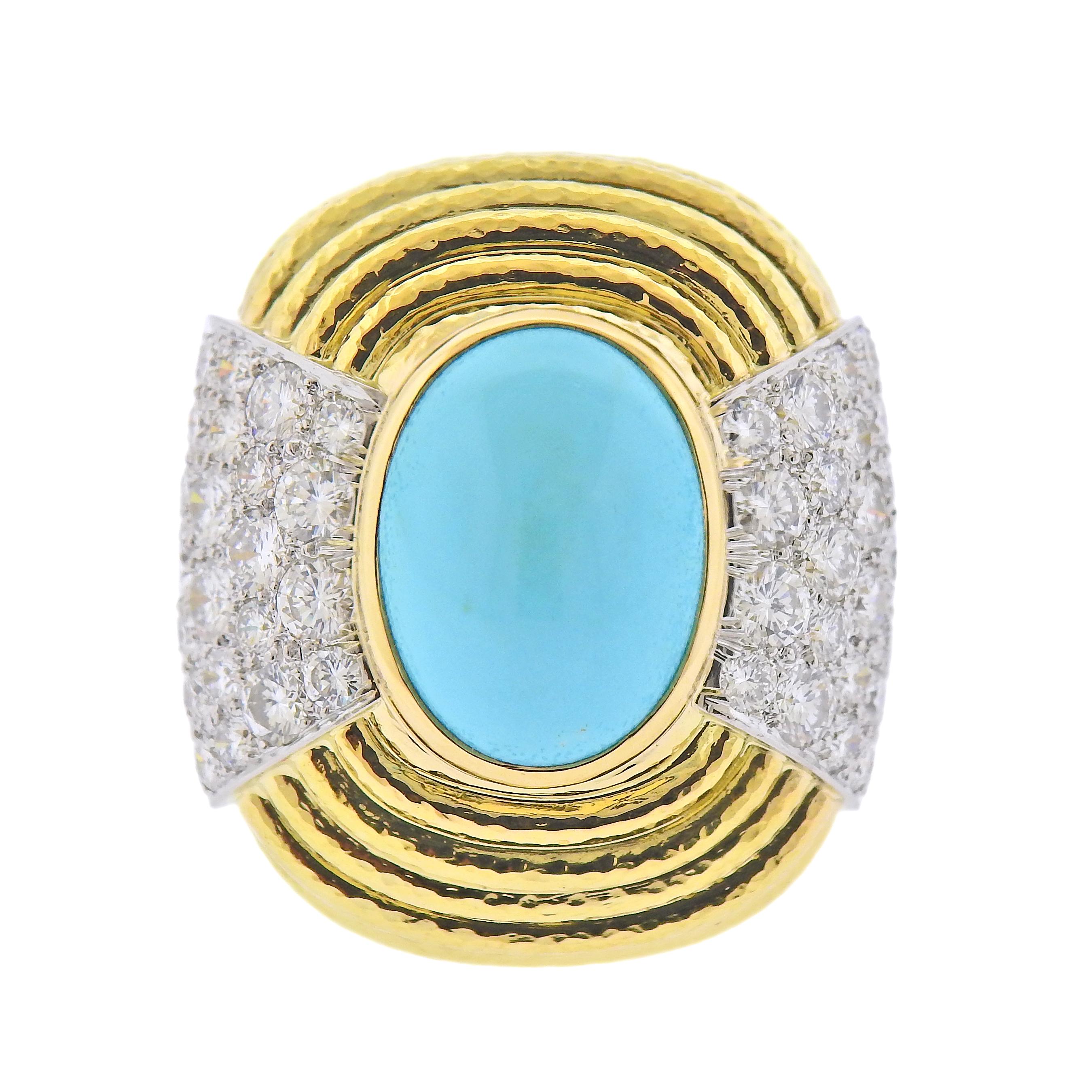 18k Yellow Gold & Platinum cocktail ring by David Webb. Set with a large turquoise center stone, surrounded by approx 2.00ctw in VS-SI/H diamonds. . 
Measurements - size 6 3/4, turquoise measures 16mm x 12mm. Marked - David Webb, 18k, 900PT. Weight