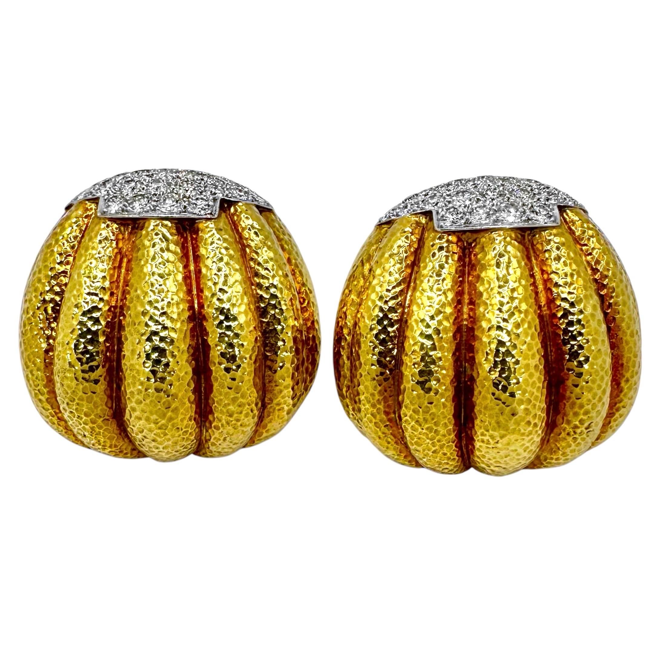 This elegant pair of vintage 18K yellow gold, platinum and diamond, finely hammered clip on earrings by venerated American designer, David Webb, showcase all of the maker's considerable imagination and style. Each deeply melon fluted bombe earring,