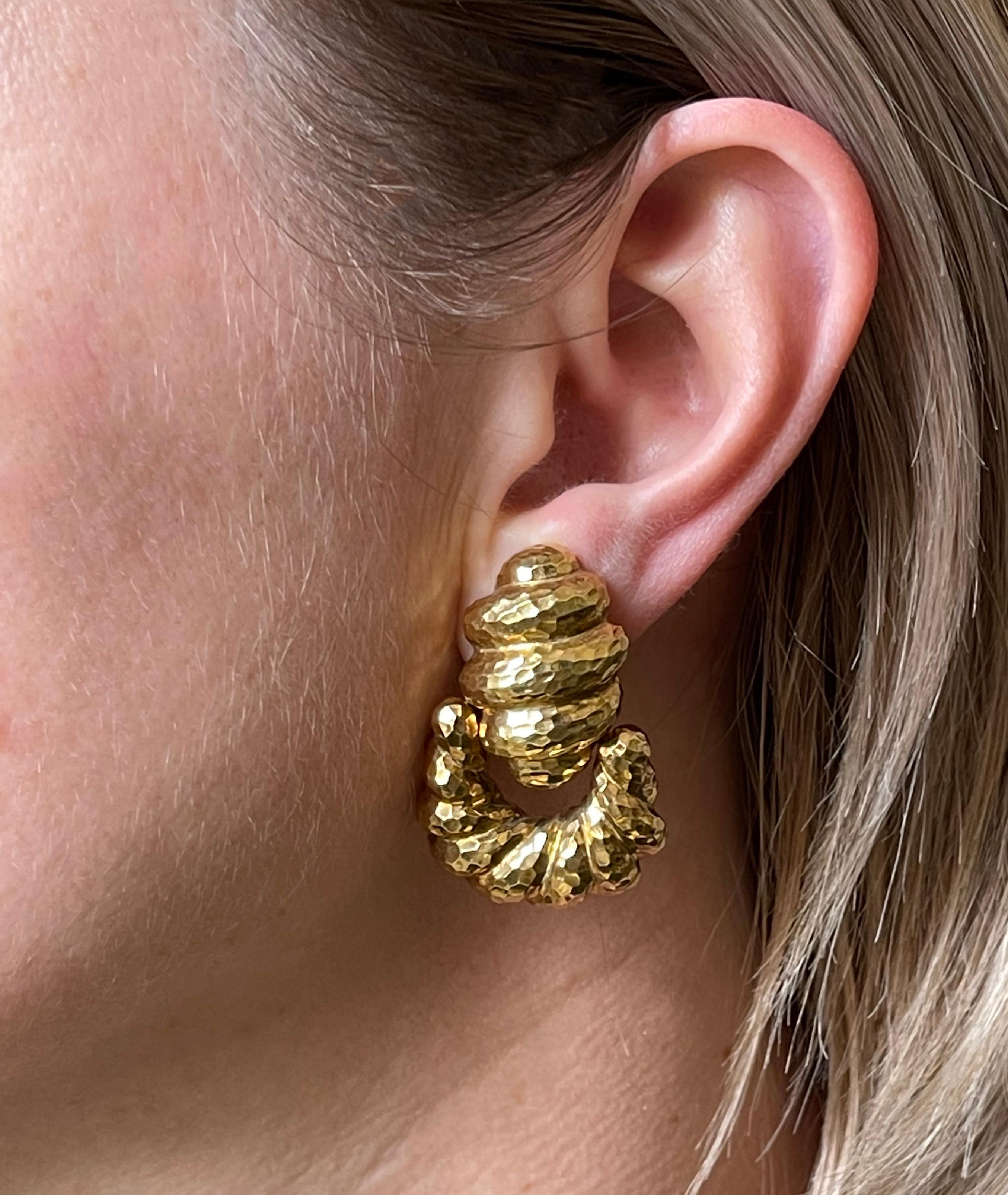 Pair of 18k hammered gold doorknocker earrings by David Webb. Earrings measure 1 5/8