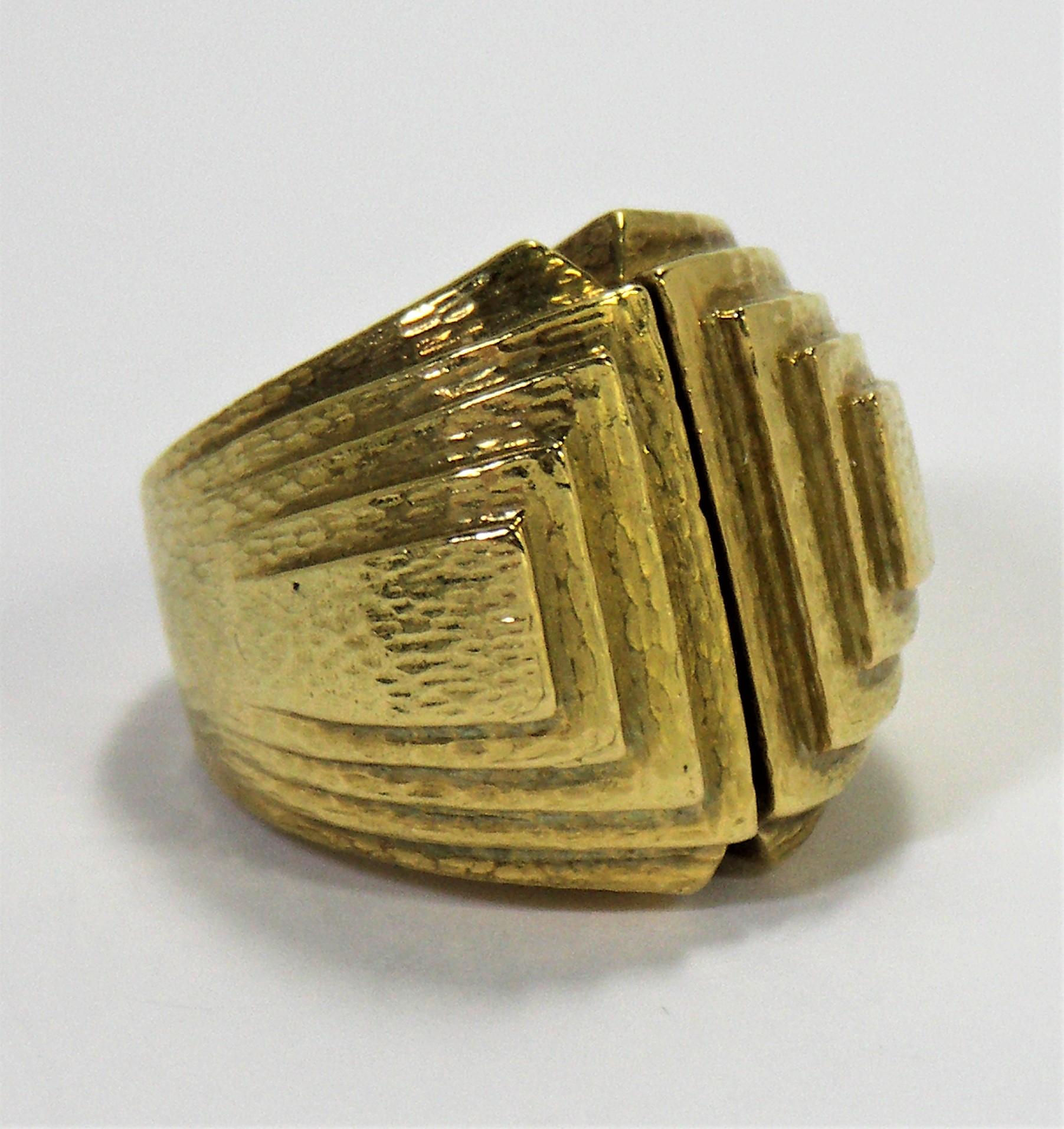 A striking 18K Yellow Gold David Webb ring from the mid 1970s. The hammered gold, geometric
design stands the test of time. This is one of David Webb's large, but not huge rings, measuring
1 inch wide (left to right) and just under 1 inch (15/16