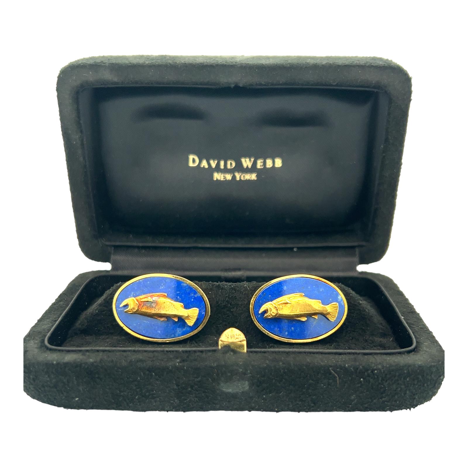 David Webb cufflinks crafted in 18 karat yellow gold. The oval gold cufflinks features lapis lazuli gemstone inlay and gold textured fish. The cufflinks measure 20 x 25mm and are signed Webb 18K. Come in original box.  The cufflinks  have not been