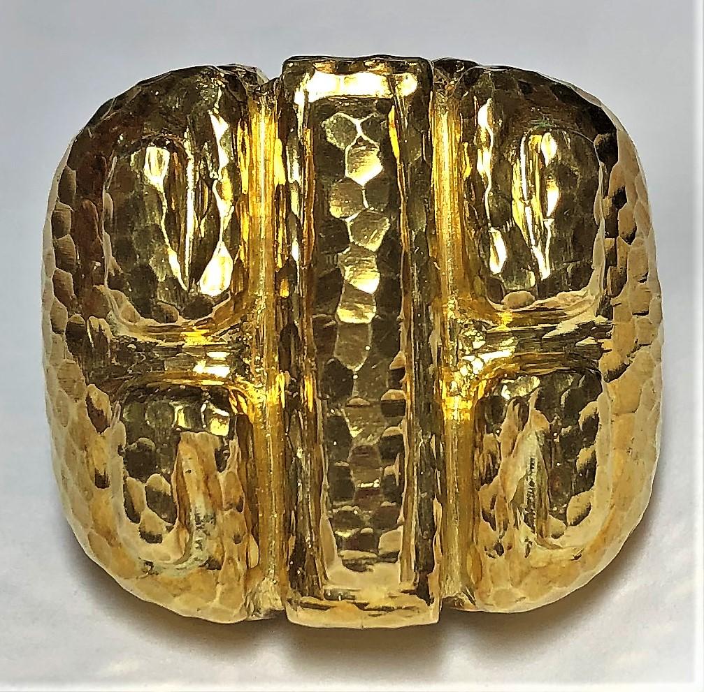 Made by David Webb, this large, hammered 18K yellow gold ring is ideal for the lady that
likes big statement rings. It measures 1 3/16 inch across by 1 1/16 inch top to bottom. The 
adjustable spring inside helps to keep the ring in place on the