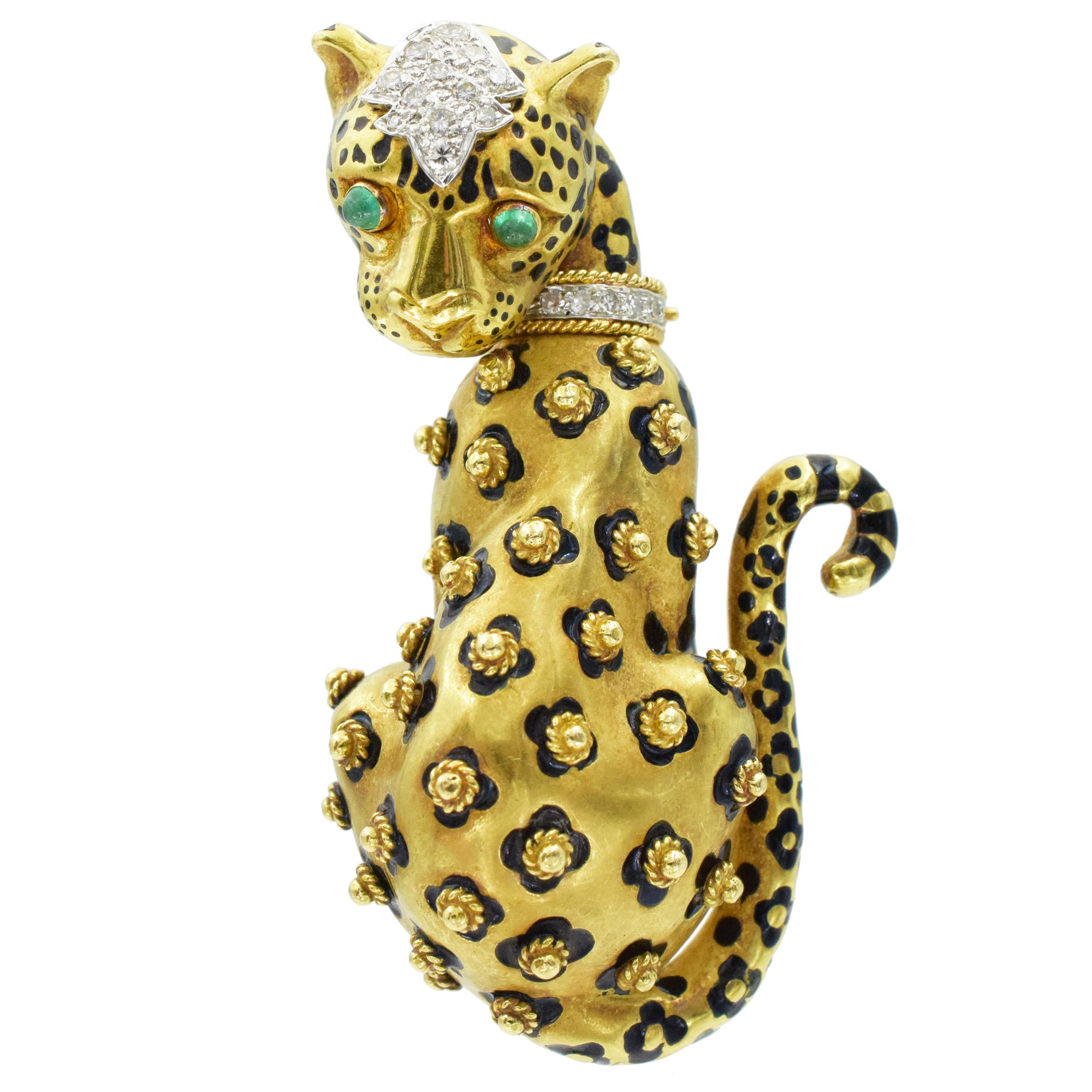 Gold, Diamond, Enamel, and Emerald Leopard Brooch by David Webb This brooch pin has a sitting leopard motif in 18k yellow gold with 2 cabochon emerald eyes in 18k yellow gold along with diamonds in the collar and head (18 round diamonds weighing