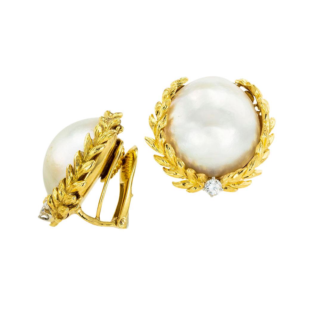David Webb mabe pearl diamond and yellow gold clip-on earrings circa 1960.  *

ABOUT THIS ITEM:  #E-DJ130i. Scroll down for specifications.  The earrings feature huge, approximately 18 mm in diameter, mabe pearls framed within laurel wreath motifs