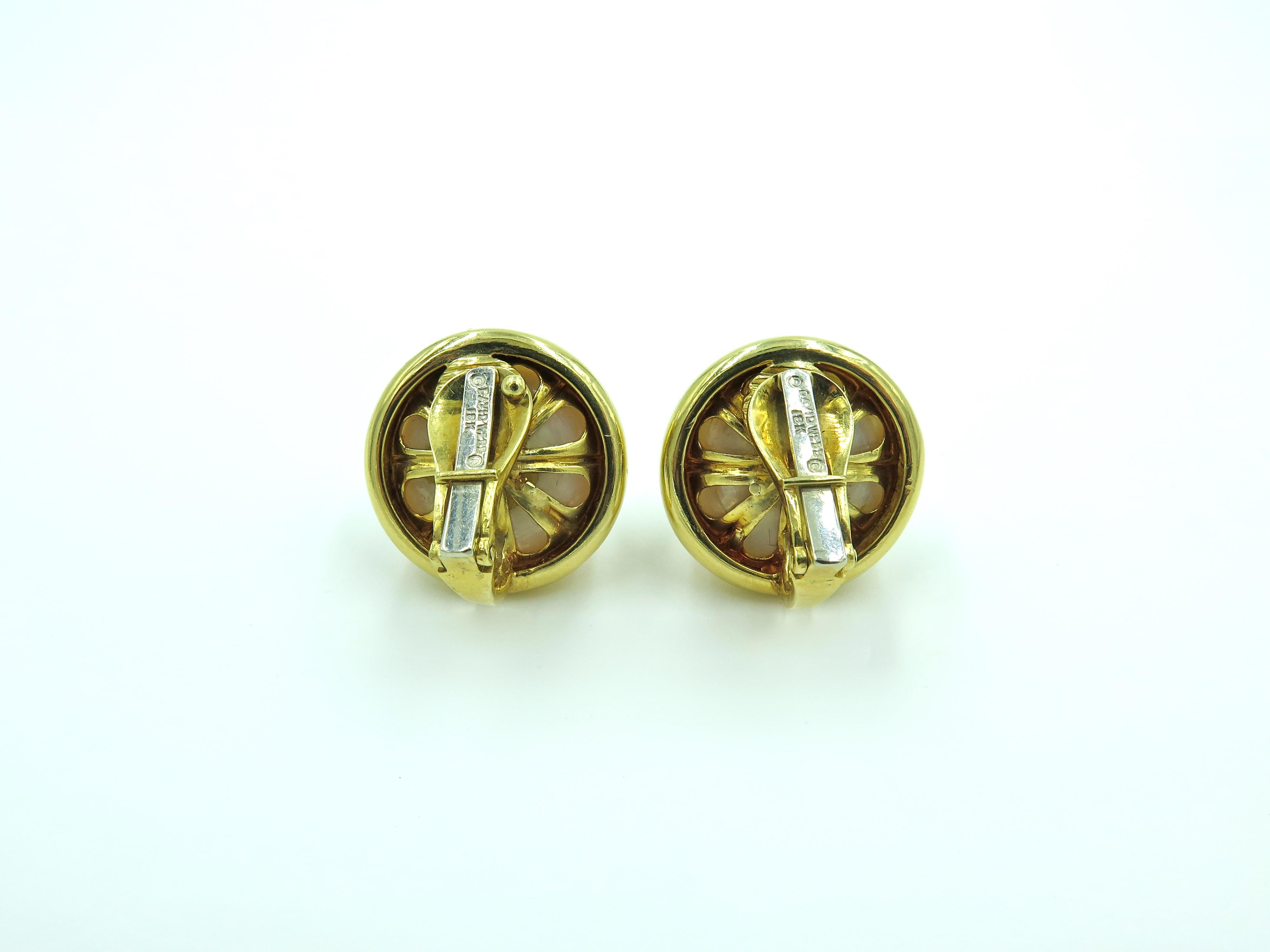 A pair of 18 karat yellow gold and mabe pearl earrings.  David Webb, Each set with a mabe pearl, measuring approximately 19.00mm. Gross weight is approximately 26.7 grams. 