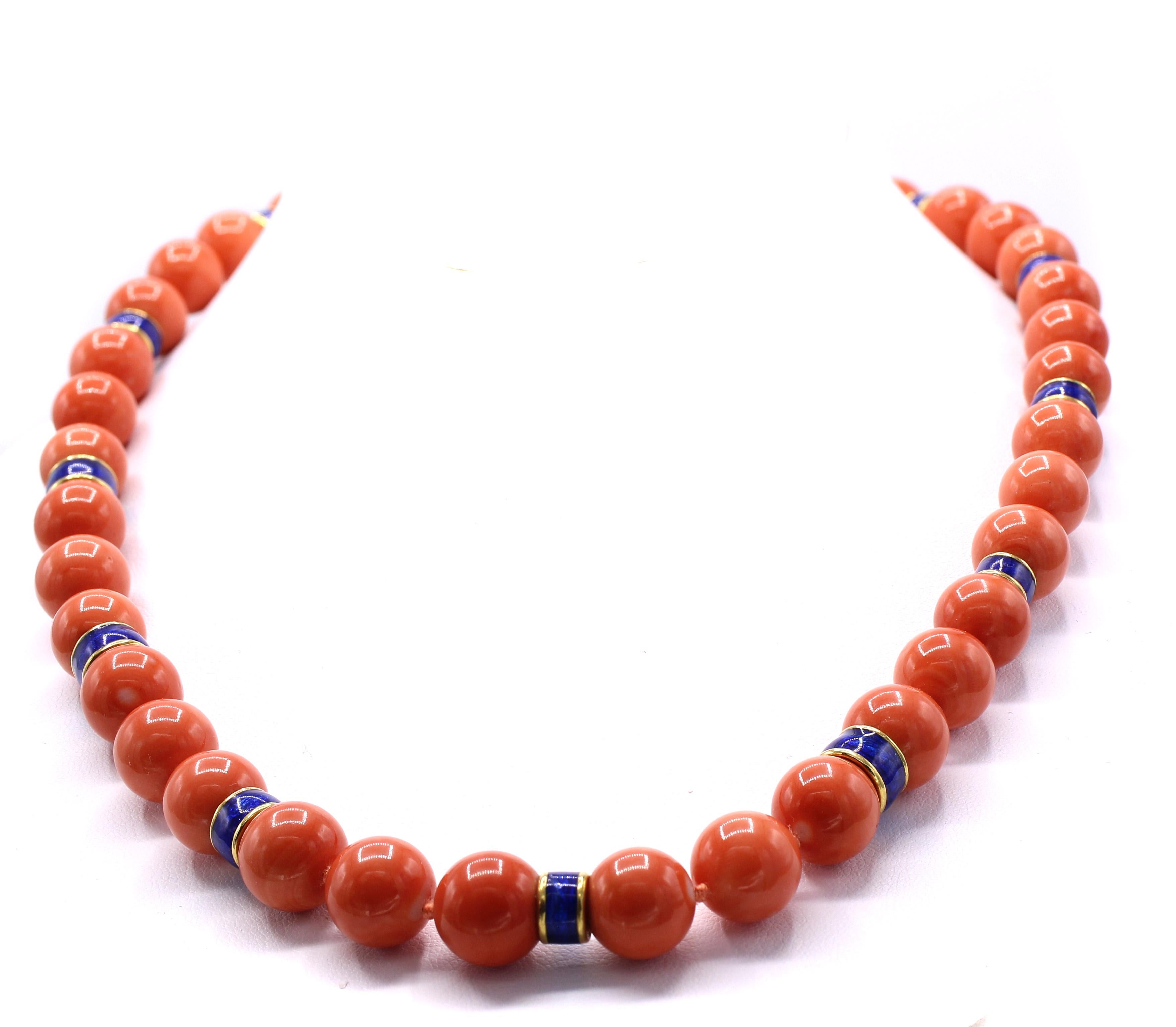 45 beautifully matched deep pink Mediterranean coral beads with an average diameter of 11 millimeters spaced by cobalt blue enamel 18 karat gold spacers are featured in this lovely and most wearable necklace by David Webb. The perfect length of