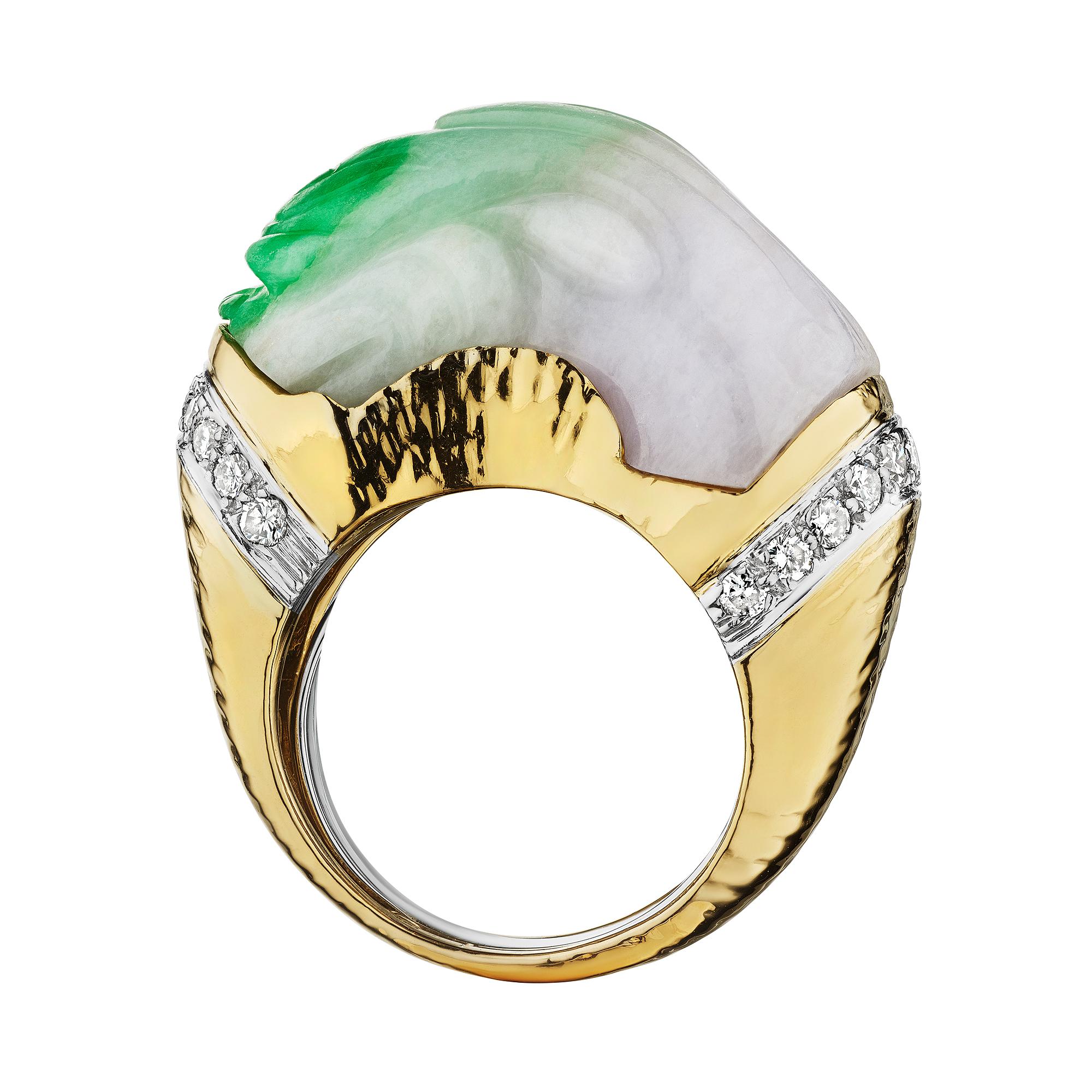 Dragons symbolize power, strength, and good luck.  Wear these virtues on your finger with this David Webb carved jade dragon head diamond platinum and gold ring.  Subtly carved with visually exciting vivid green splashes of color, this jade ring is