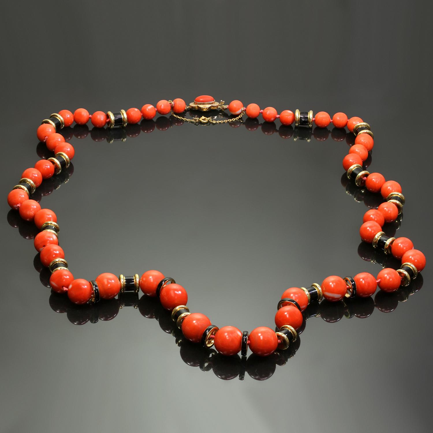 This long magnificent David Webb necklace features 47 natural red coral beads measuring 8.2mm to 14.5mm in diameter, spaced by black enamel 18k gold rondels and completed by a quaterfoil 18k gold  oval coral clasp signed WEBB for David Webb and