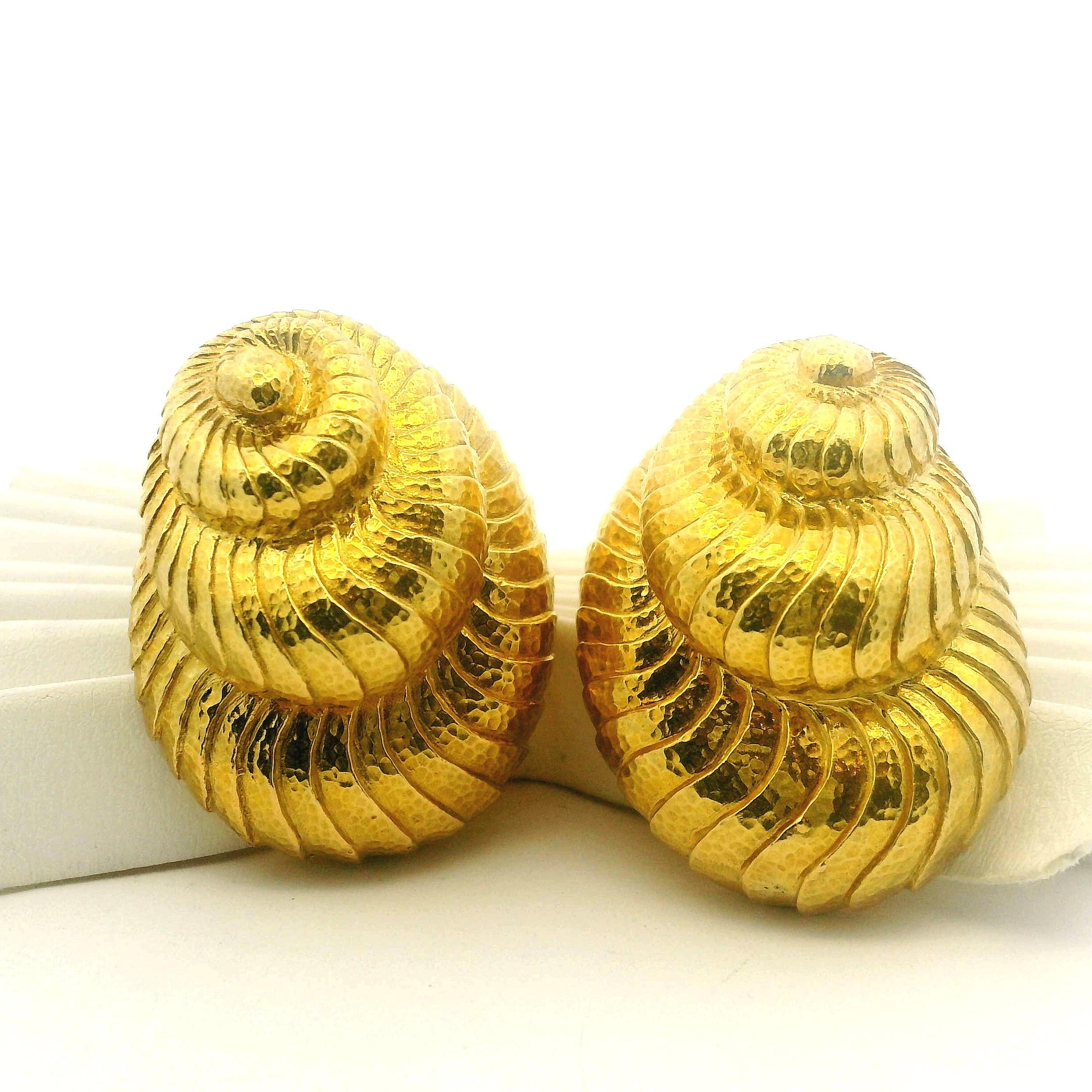 A stunning and sculptural pair of David Webb earrings designed in the form of stylized nautilus shells, beautifully textured in hammered 18 karat yellow gold. The undulating ridges and spiraled contours capture Webb’s signature balance of bold