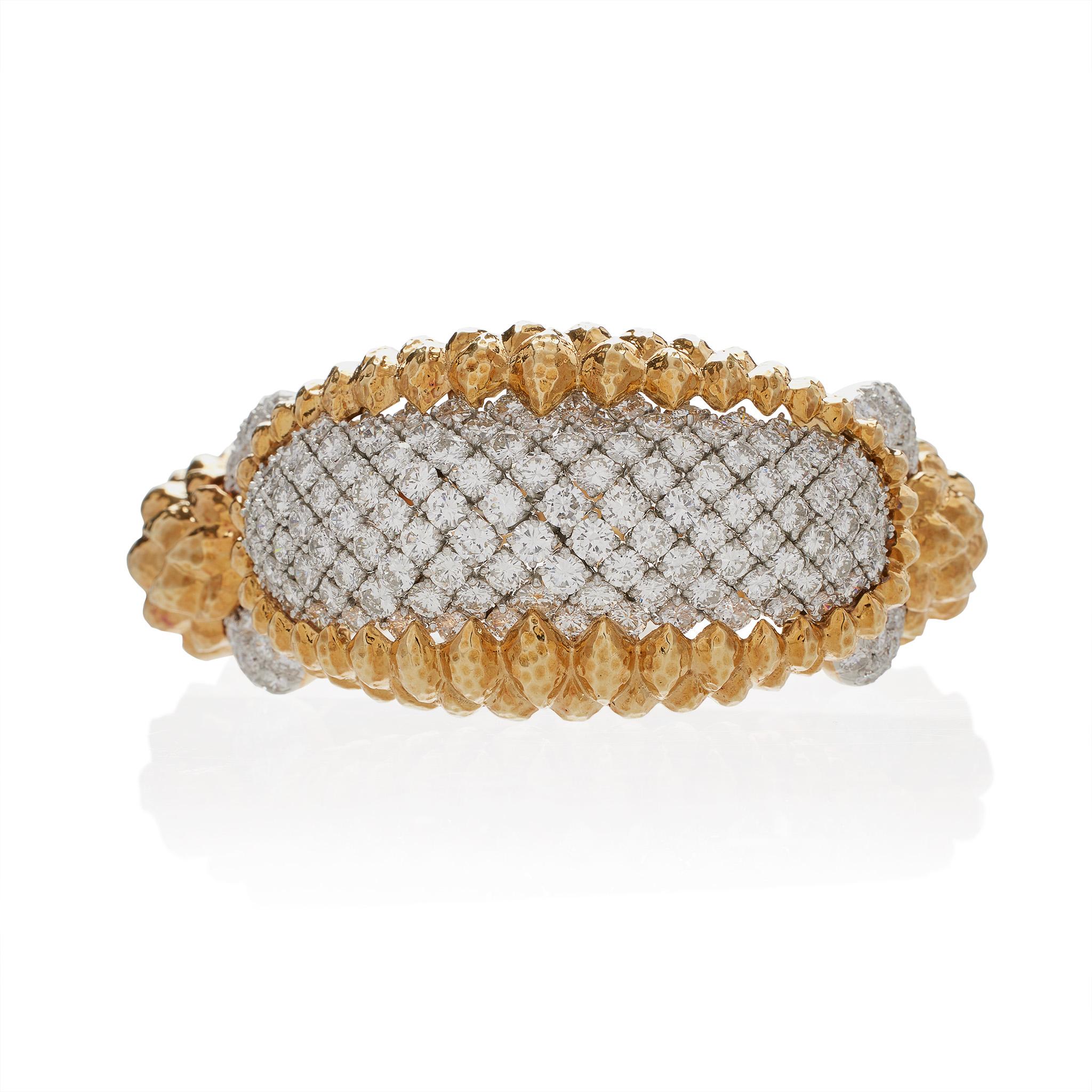 Created in the 1960s in the studio of David Webb, this one-of-a-kind “Crosshatch” diamond bracelet in 18K gold and platinum is set with over 16.50 carats of diamonds. The bombé curved top section is paved with round brilliant-cut diamonds arranged