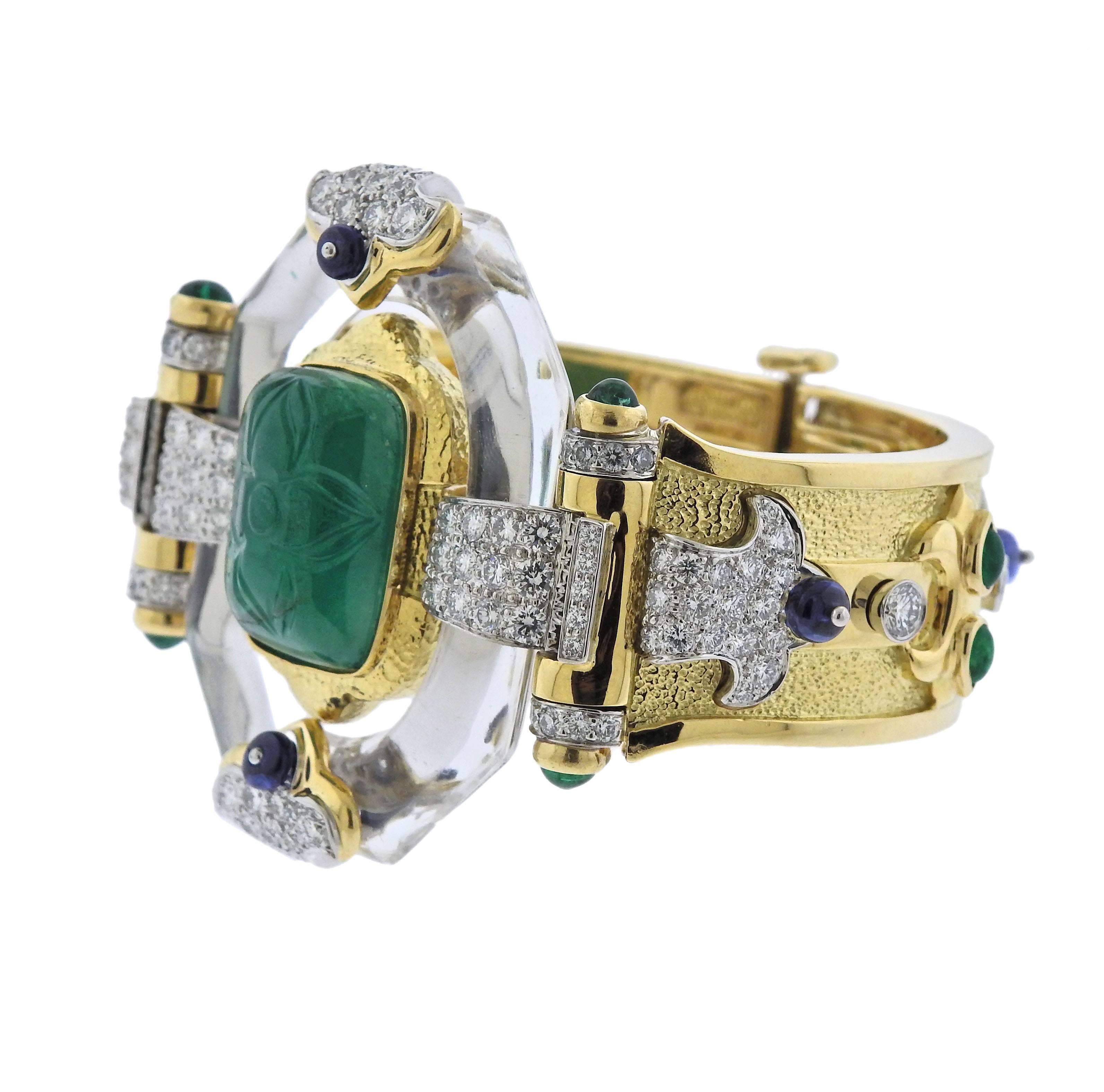  Impressive one of a kind bracelet, crafted by David Webb, decorated with approx. 20cts carved emerald, 1.34ctw in emerald cabochons, 5.09ctw GH/VS diamonds and 2.91ctw in sapphires and rock crystal. Comes with Webb COA. Bracelet will fit approx.