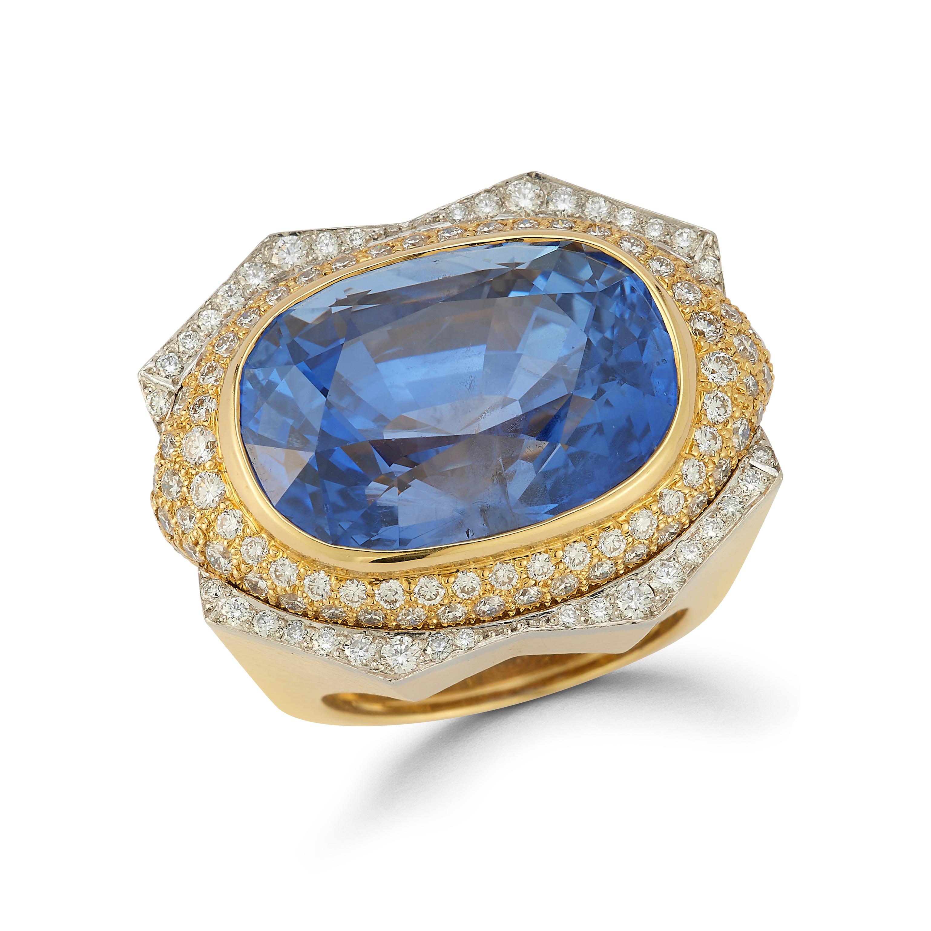 David Webb Oval Cut Sapphire Men's Ring,

1 oval sapphire set west to east. Surrounded by round cut diamonds set in 18k hammered yellow and white gold 

Sapphire Weight: 32.60 Carats 

Diamond Weight: 1.75 carats 

Accompanied by a certificate of