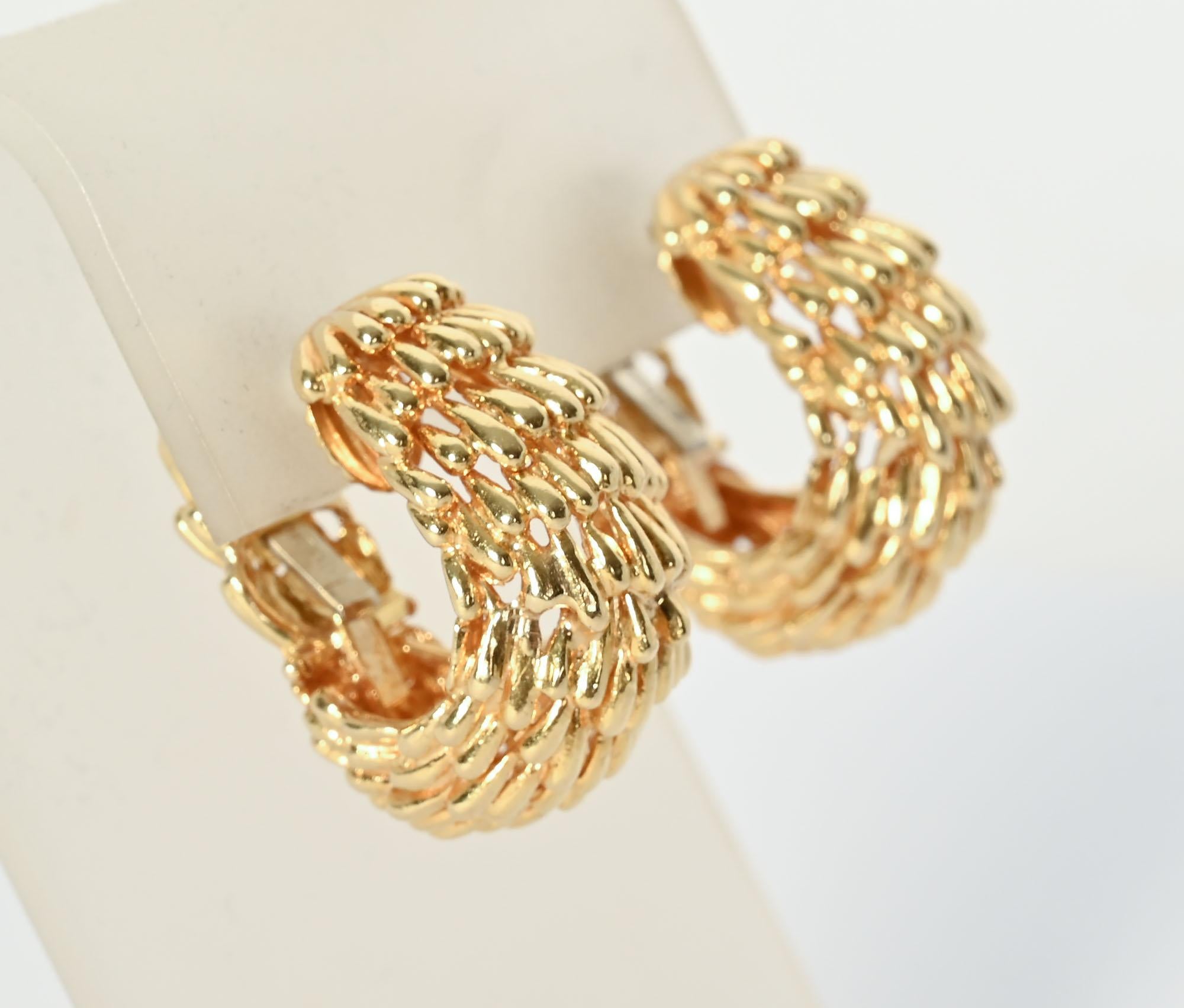 David Webb oval hoop earrings made of small strokes of gold. They look as though they were made with a tiny paintbrush.
No effort was spared as the design continues throughout the back. The earrings are cleverly made with an invisible hinge in the