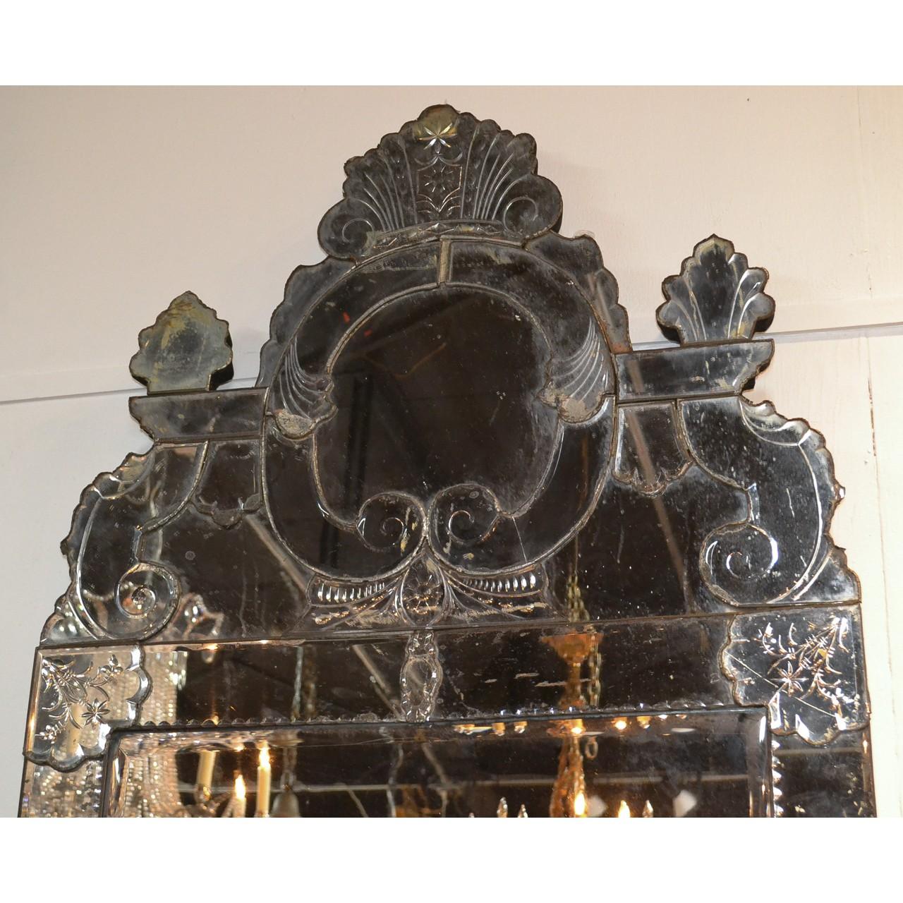 Magnificent 19th century Venetian glass silvered mirror of palatial size with a beautifully shaped crest and etched decorations. The mirror has a hardwood backing,

circa 1880.