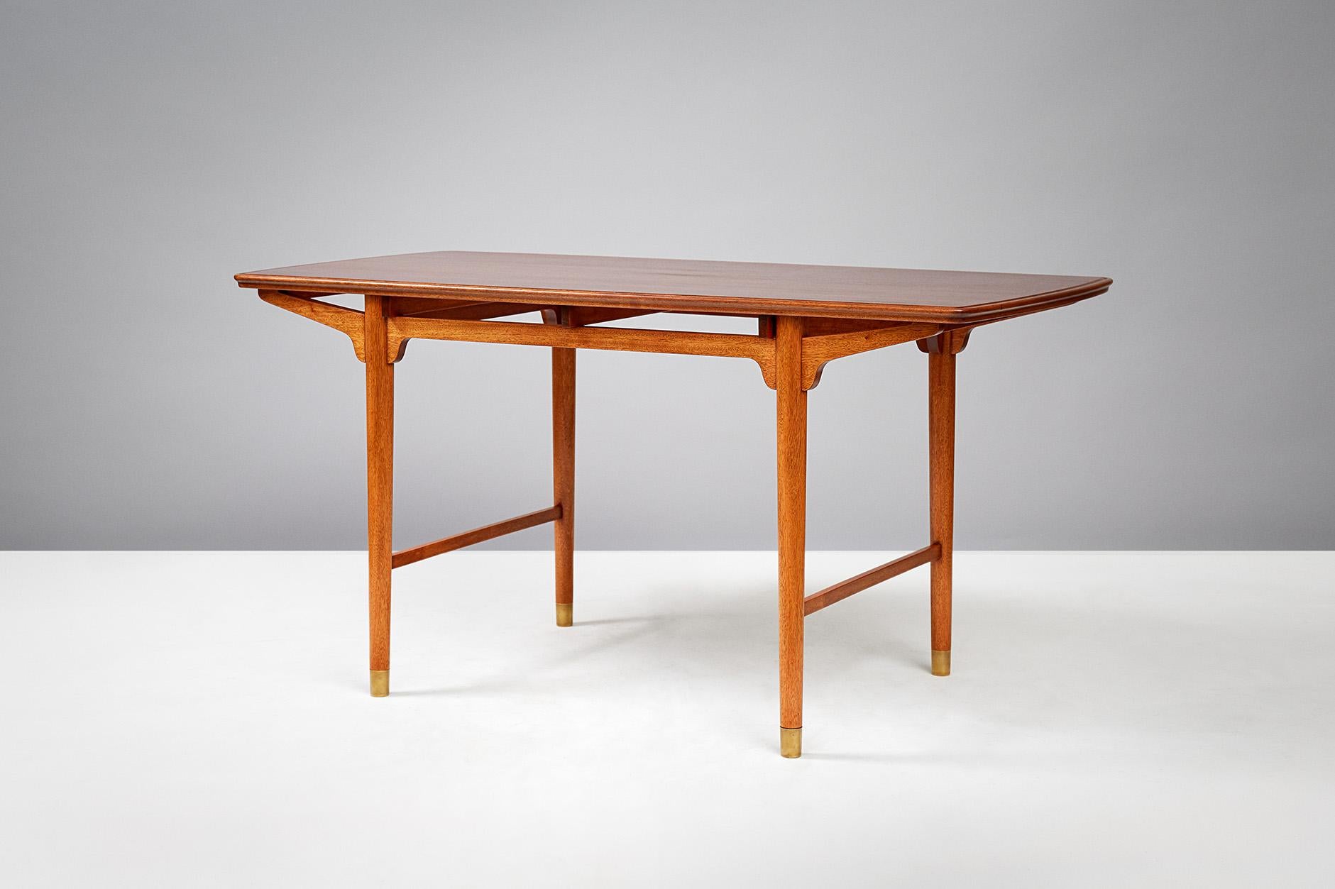 Frode Holm
Occasional table, circa 1950.

Produced in Denmark for the Illums Bolighus department store in Copenhagen, circa 1950. Constructed from African Sapele Mahogany with patinated brass shoes.