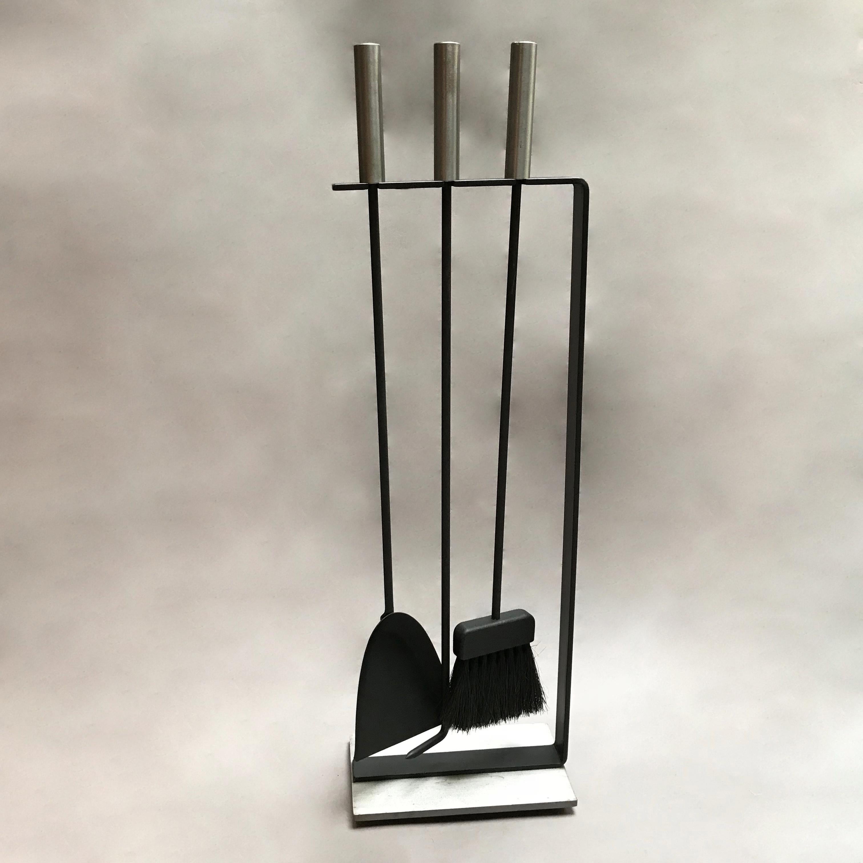 Modernist, wrought iron, fireplace tool set by Pilgrim attributed to George Nelson features 3 tools in a minimalist open frame with brushed chrome base and handles.