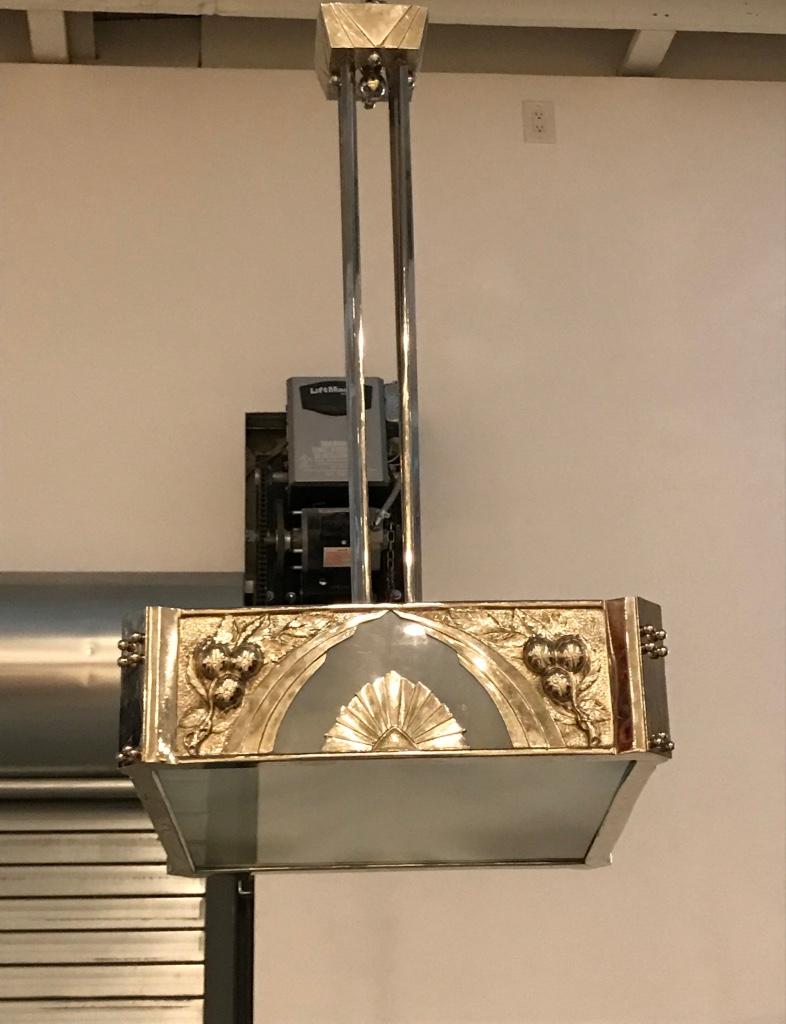 French Art Deco chandelier having frosted glass panels. Held by polished nickel frame with incredible deco details throughout. The chandelier has been rewired for American use. With eight candelabra sockets. Each socket has a max watt of 60 watts