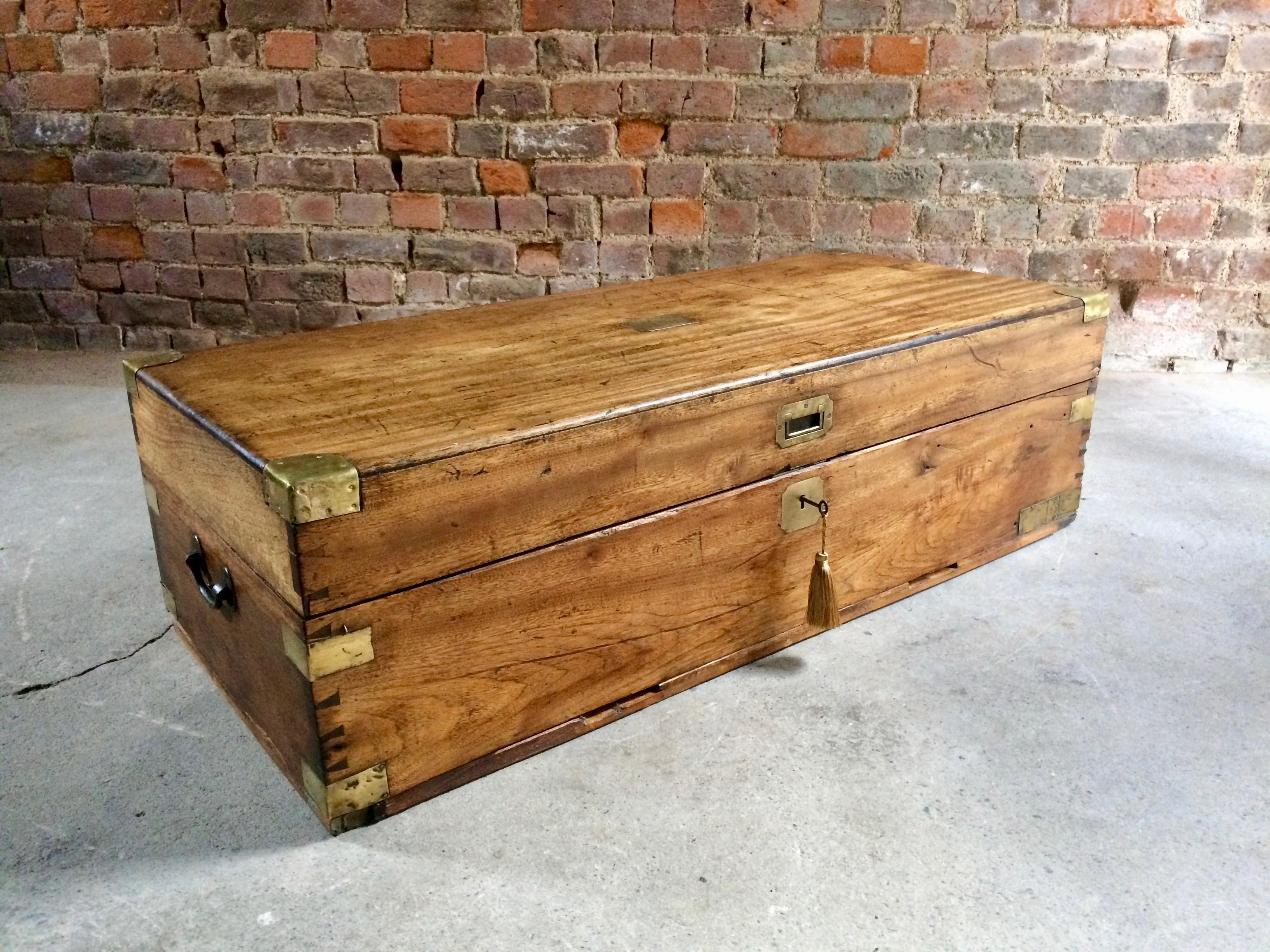 Large antique 19th century teak brass bound campaign travel trunk chest, circa 1870, the rectangular top complete with brass plaque with the name Nelson RN stamped and brass corner protectors lift up lid with small candle box within, comes with one