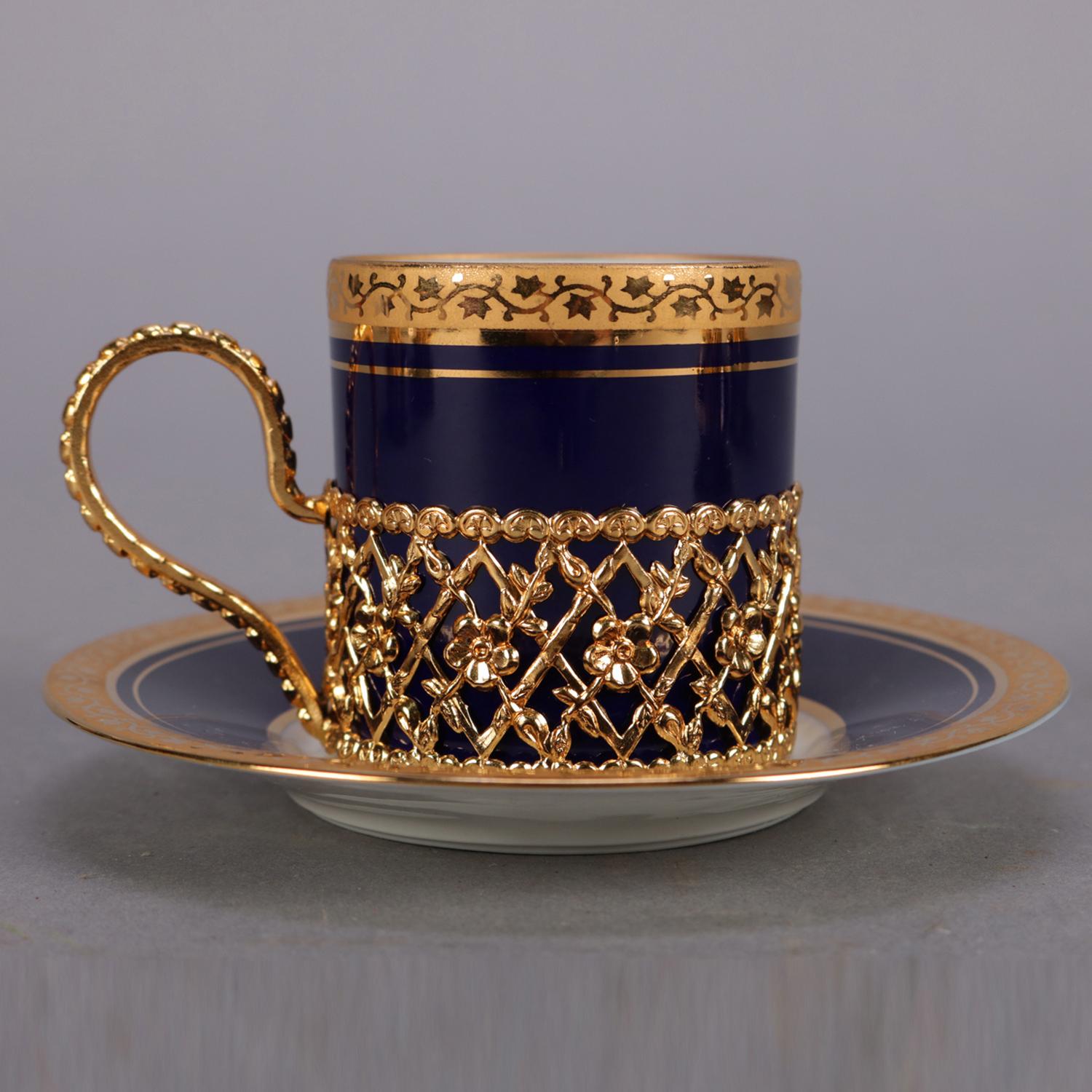 Set of 6 French Limoges porcelain demitasse cups with saucers feature cobalt blue glazing with gilt banding having foliate decoration, cups seated in pierced gilt metal floral and foliate handled baskets, en erso crown and shield Limoges stamp,