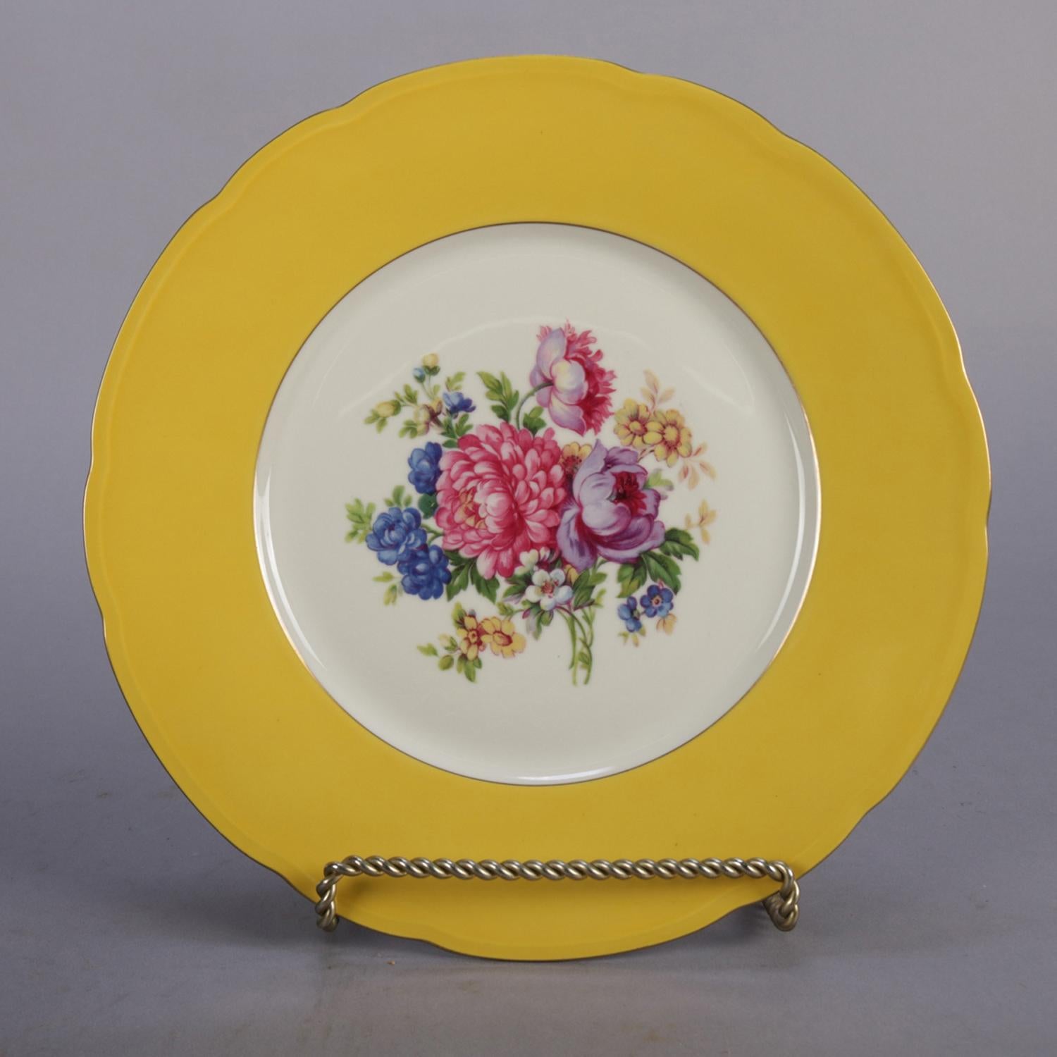 Set of 12 vintage Czech porcelain dinner plates feature slight scalloped and gold rims with gilt trimming and central floral bouquet, en verso maker mark 
