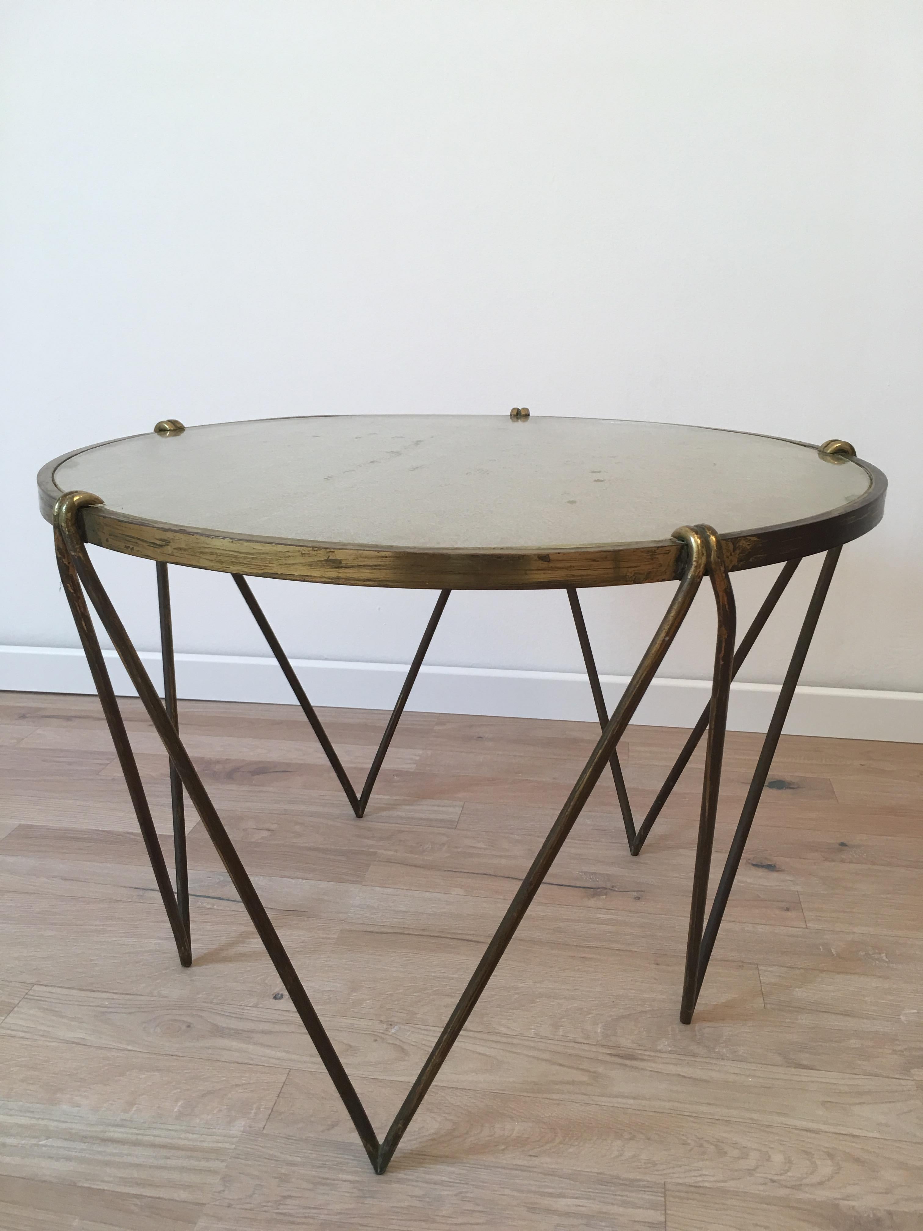 1950s French coffee table with an original Saint Gobain slab glass, supported by a gilt metal frame.
The geometrical shaped base is composed of five triangles. Perfect design and high quality of materials that reminds the work of Jean