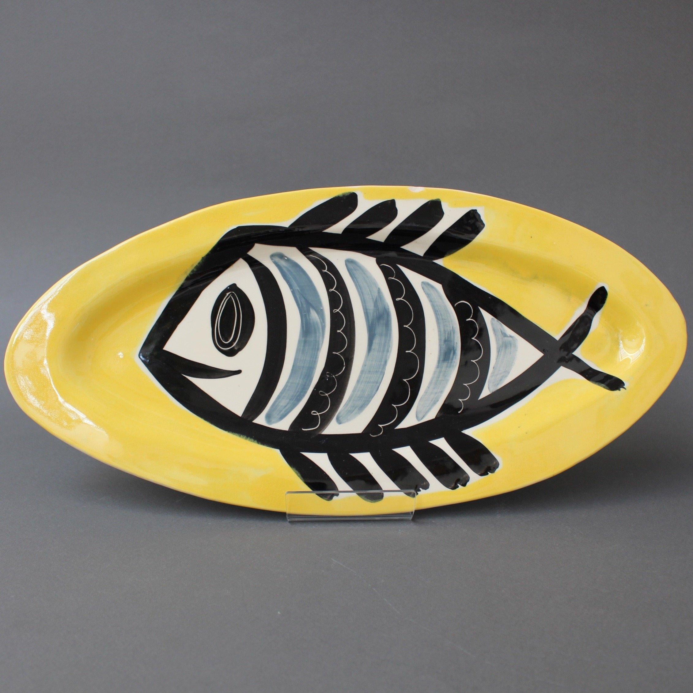 Poët-Laval decorative ceramic platter with fish motif by Jacques Pouchain (c. 1960s). This rare platter incorporates an image of a stylised fish in black and grey on a bright yellow background. It is inspired by Picasso's ceramics made in Vallauris,