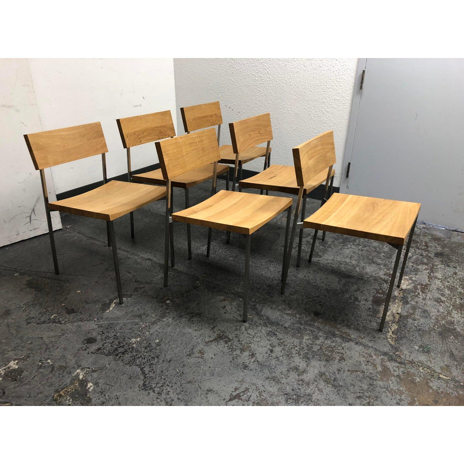 A set of six CH03 Henning designed by Philipp Mainzer for E15. This set of six side chairs is all in the options of oiled oak and stainless steel, offering a modern, fresh, and uniform appearance to the set. An ideal complement to a round kitchen