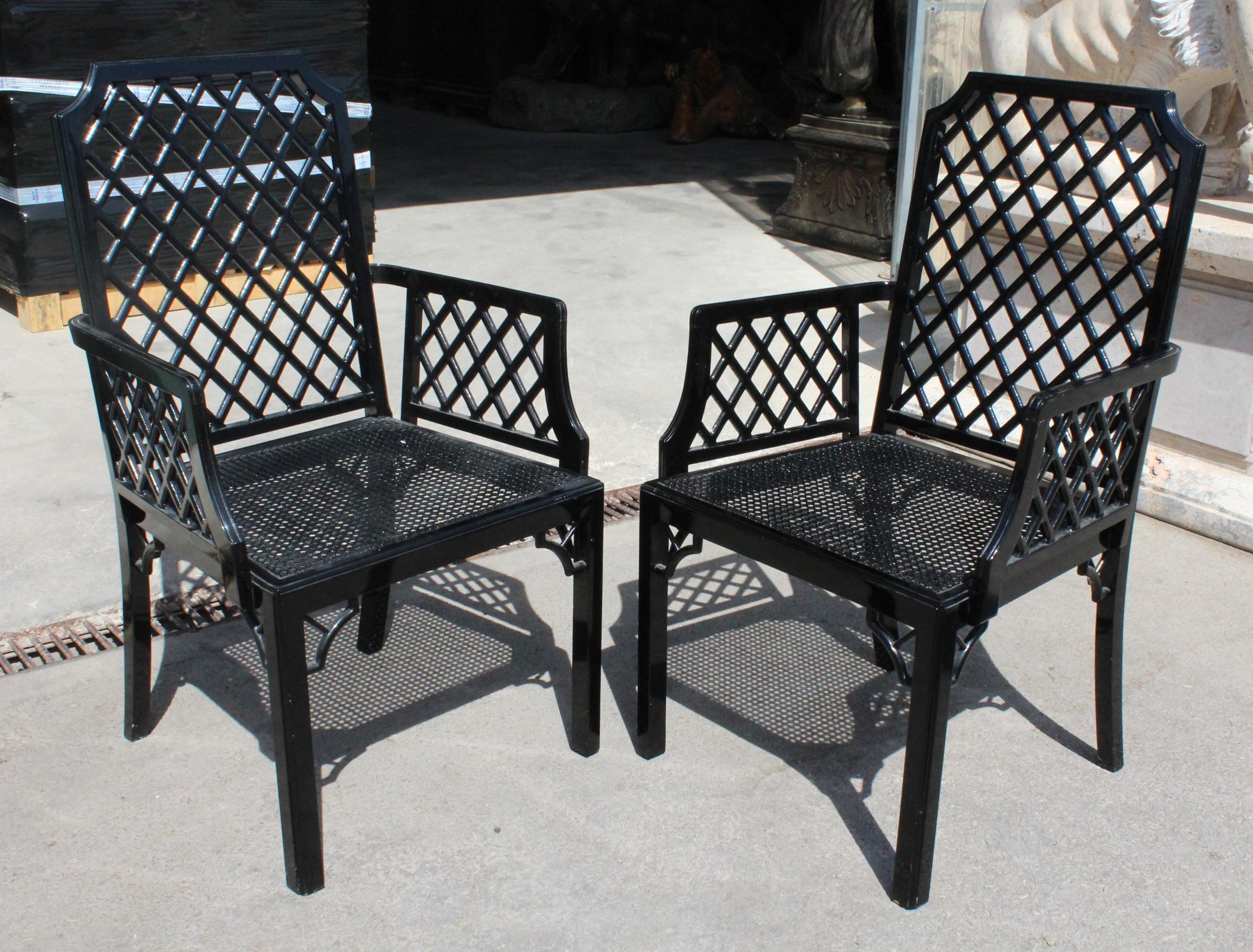 1980s pair of English black lacquered armchairs with grid pattern backrest.