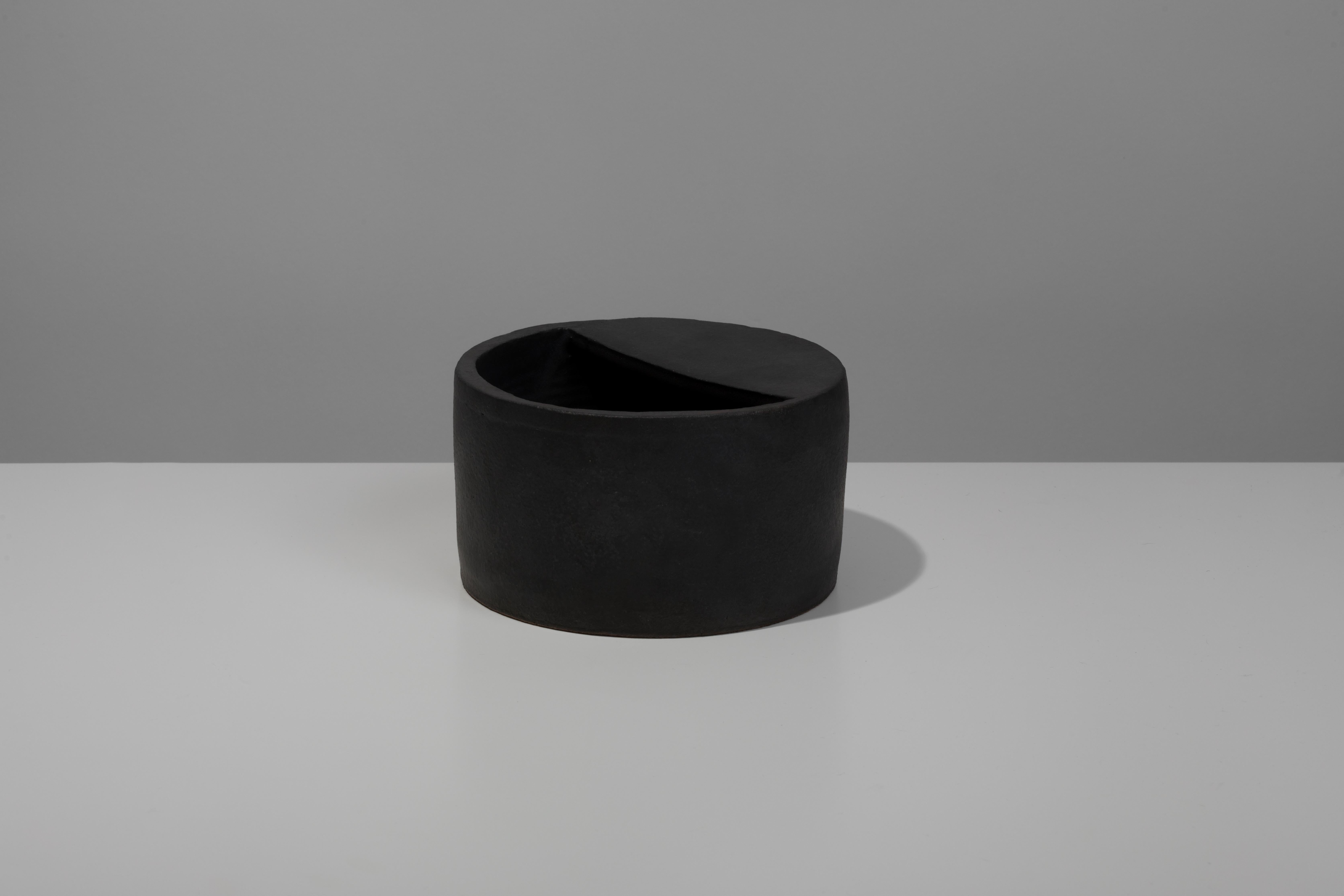 Wheel-thrown and slab-built ceramic vessel with black coppered glaze. Marked with an engraved bronze label to underside: Jonathan Nesci w/ Robert Pulley 18/06. 

Designed by Jonathan Nesci and made in Columbus, Indiana by local ceramist Robert