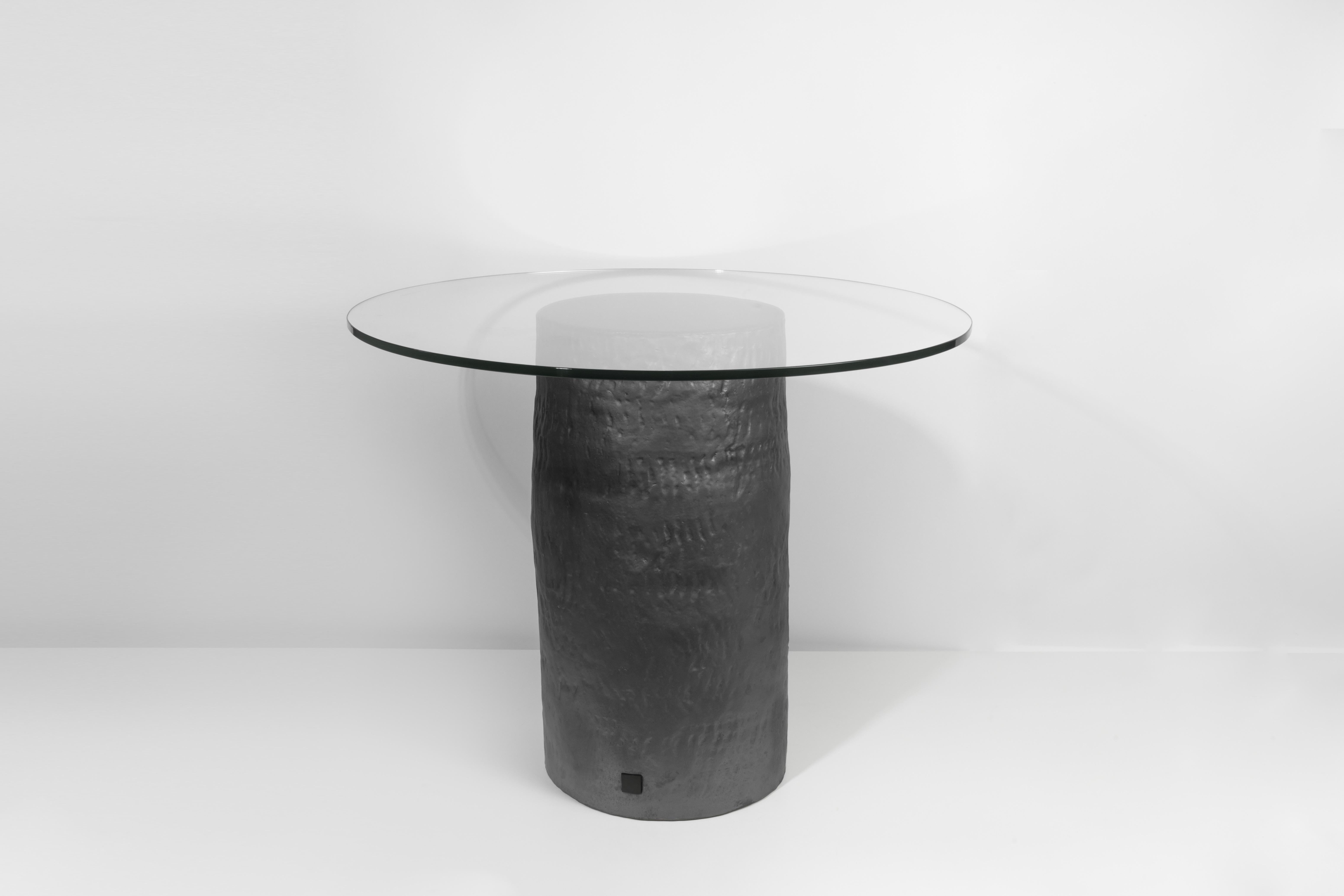 Coil-built ceramic table with black coppered glaze and glass top. Marked with an engraved bronze label to underside: Jonathan Nesci w/ Robert Pulley 18/20. Unique work and form from a closed collection of 20 designs. 

Designed by Jonathan Nesci and