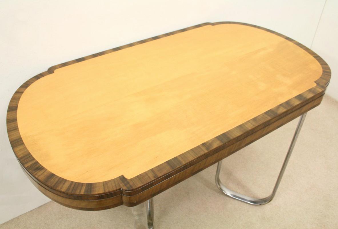 Stylish and unusual maple and walnut table, probably by Heals of London. The maple veneered top is crossbanded in walnut. The edge of the table has a triple moulding with different coloured walnut on each level. The undercarriage has four flattened