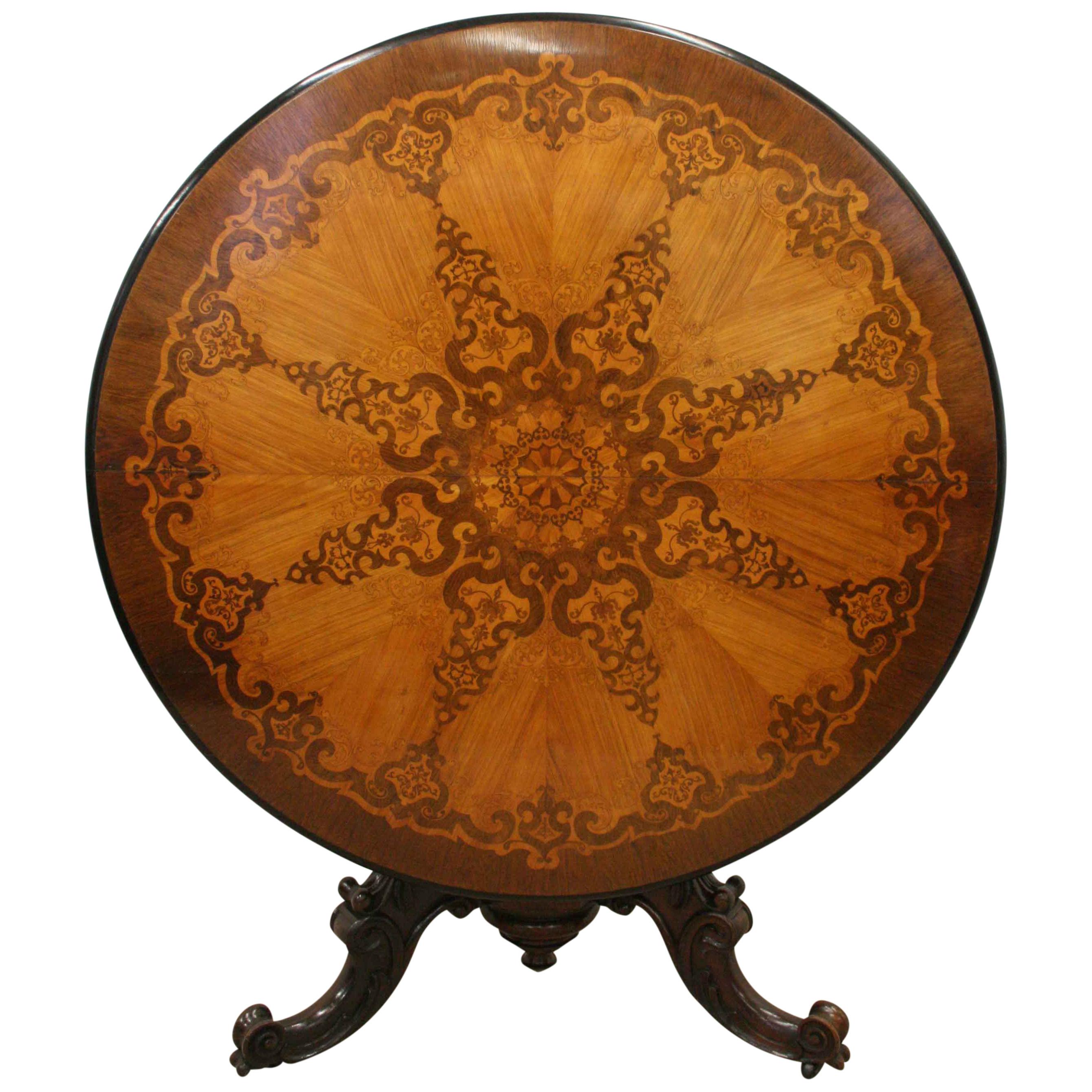 An exhibition quality Victorian rosewood, walnut and kingwood marquetry inlaid circular breakfast table, circa 1860. The table has a moulded and ebonised fore-edge and has been made with segments of various veneers. These veneers taper down towards