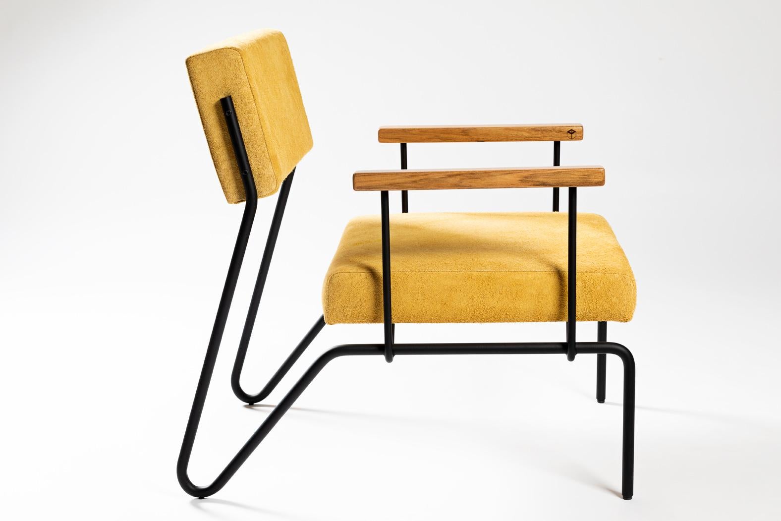 This award winning minimalist armchair in steel, solid wood and leather is designed with a Classic and geometric reasoning. 
The continuity of the structural lines suggests fluidity. The backrest allows a smooth movement and just like the seat, it