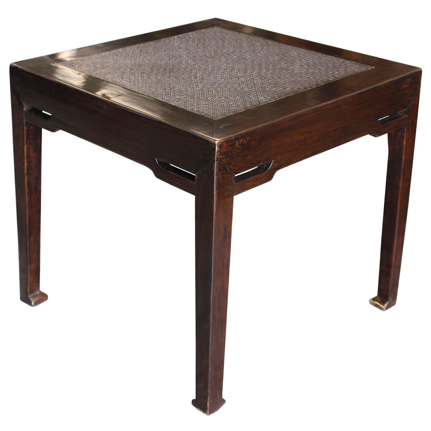 Elegant elmwood Ming tables with horse hoof-style feet and woven rattan top can be used as a coffee or side table in the living room.