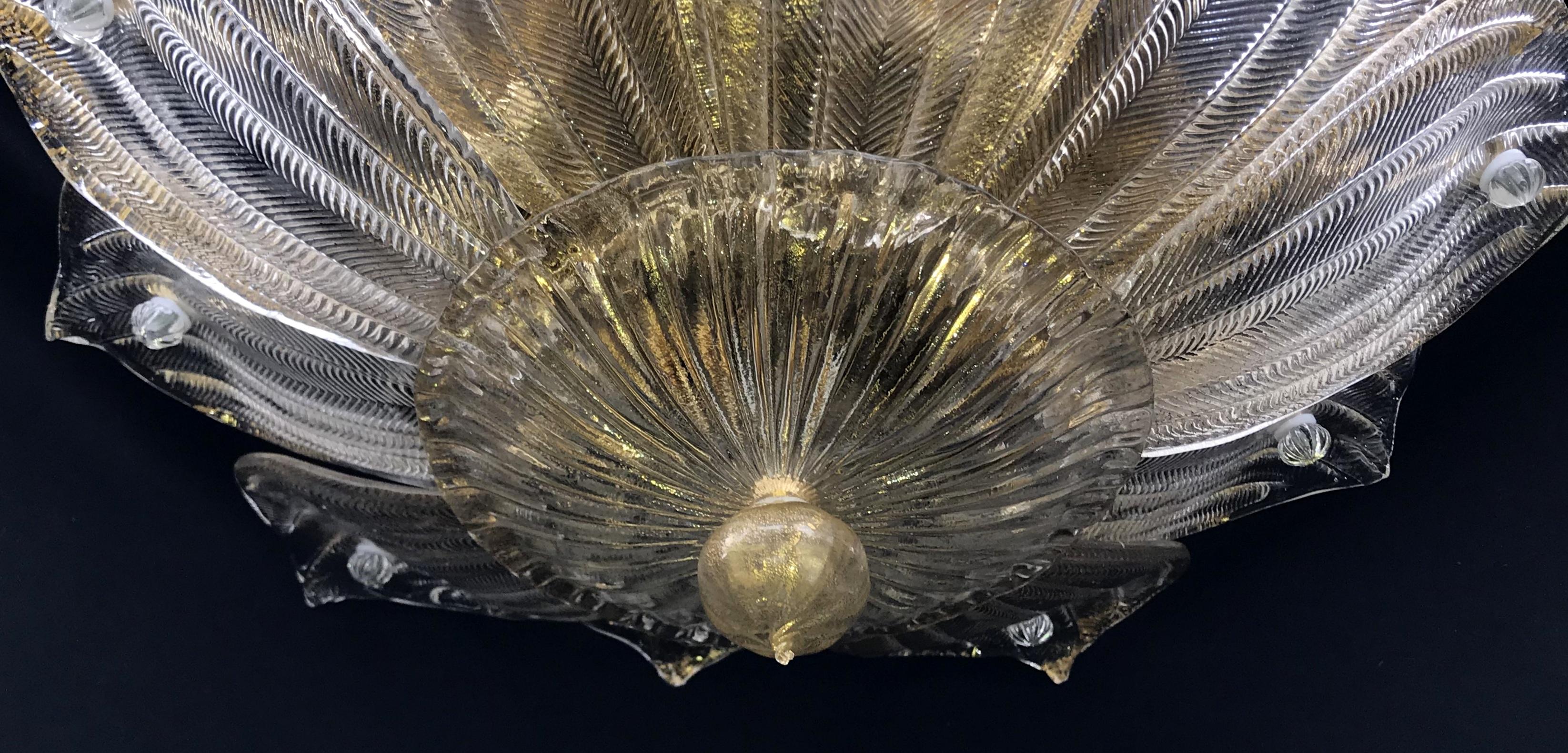A vintage Mid-Century Modern Italian leaf clear and gold Murano glass flush mount chandelier Light Fixture in the manner of Seguso, Fitted with four Candelabra sockets rewired and ready to enjoy.
