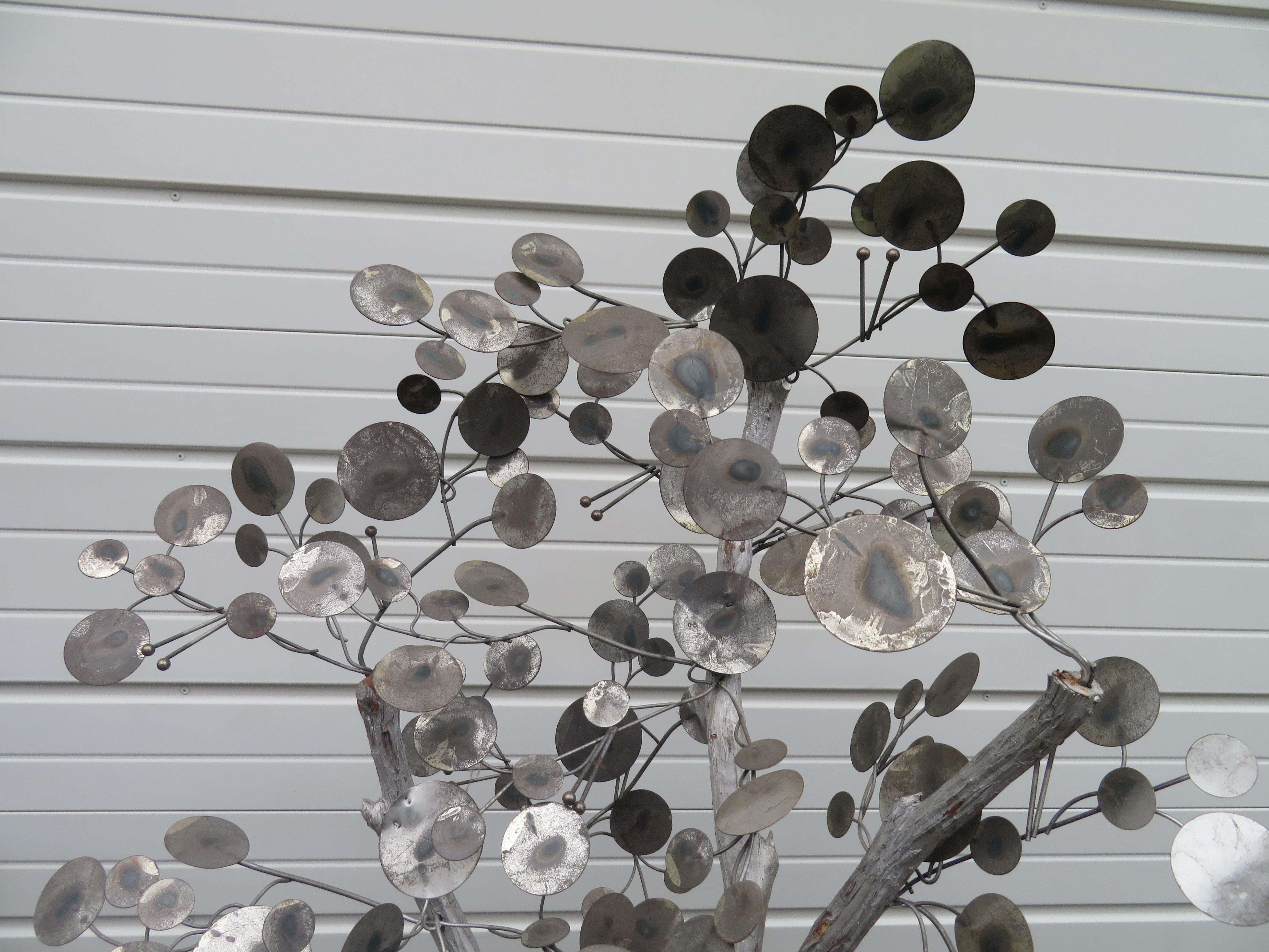 Whimsical Curtis Jere chrome raindrops tree. This piece shows quite a bit of oxidation to the raindrops leaves but we are loving it just the way it is.