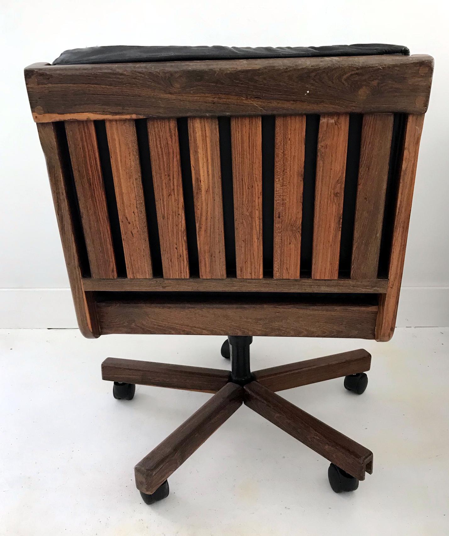 A solid cocobolo wood chair made for desk task by Don S. Shoemaker circa 1970s in Mexico. The chair has padded arm with leather and loos leather seat and back cushions. Subtle design with organic form highlights the beauty that can be found in